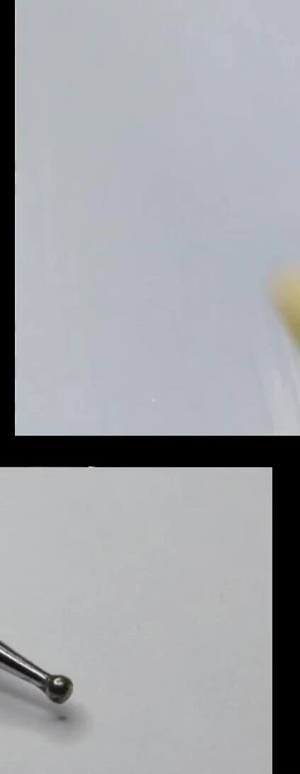 Applying yellow polish background with a dotting tool.
