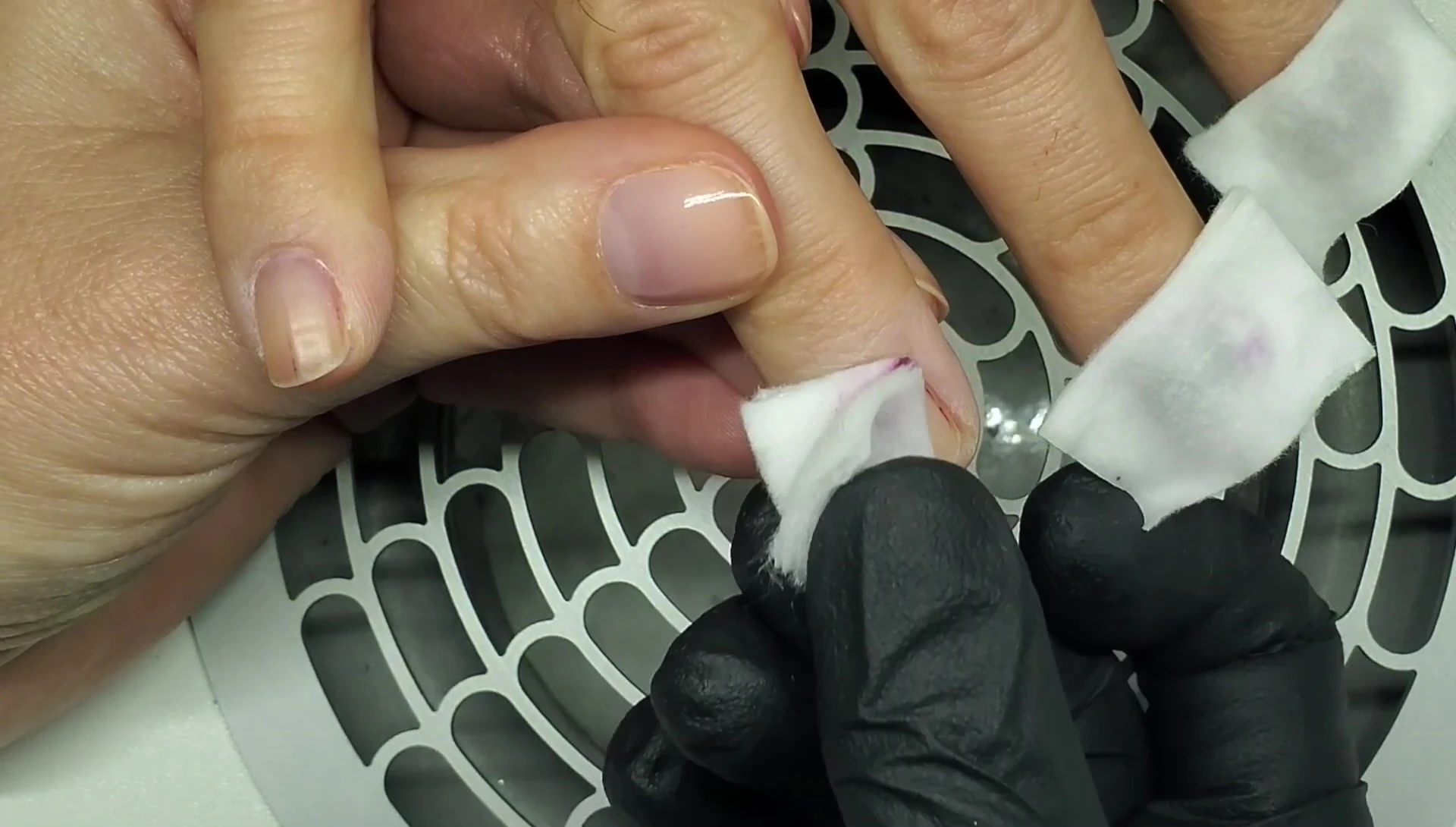 Pulling off the acetone-soaked pad