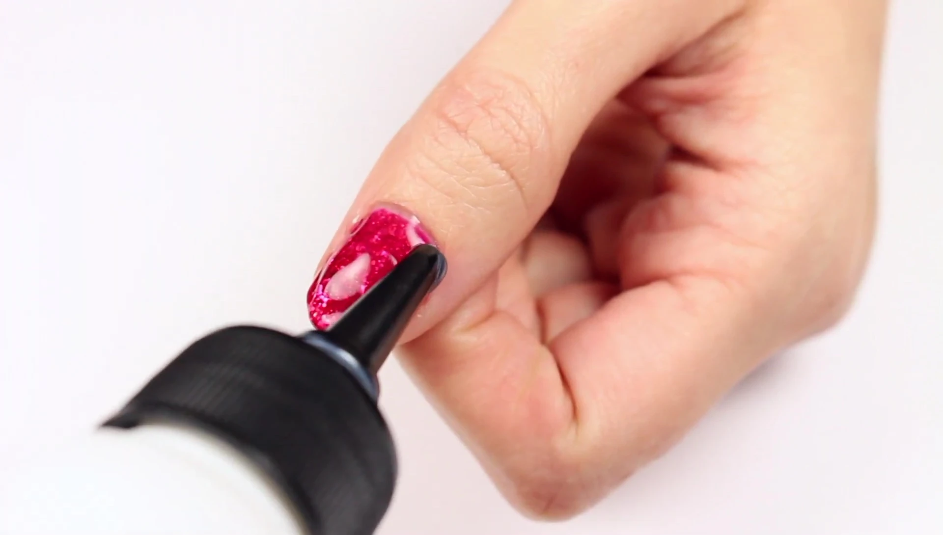 Applying the remover to the glitter polish