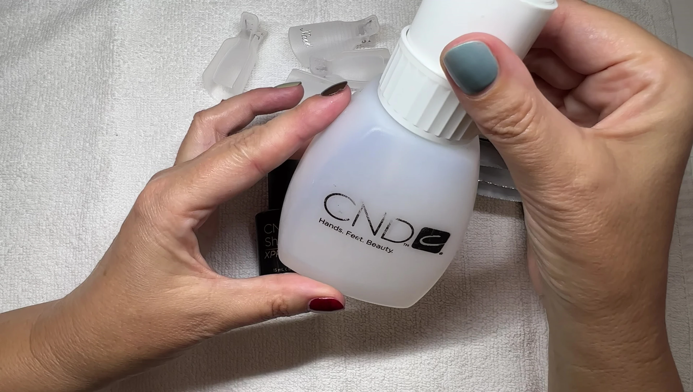 Hand holding a bottle of acetone.
