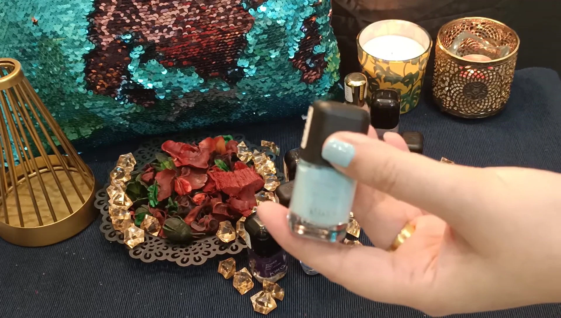 The maroon nail polish swatched on nails.