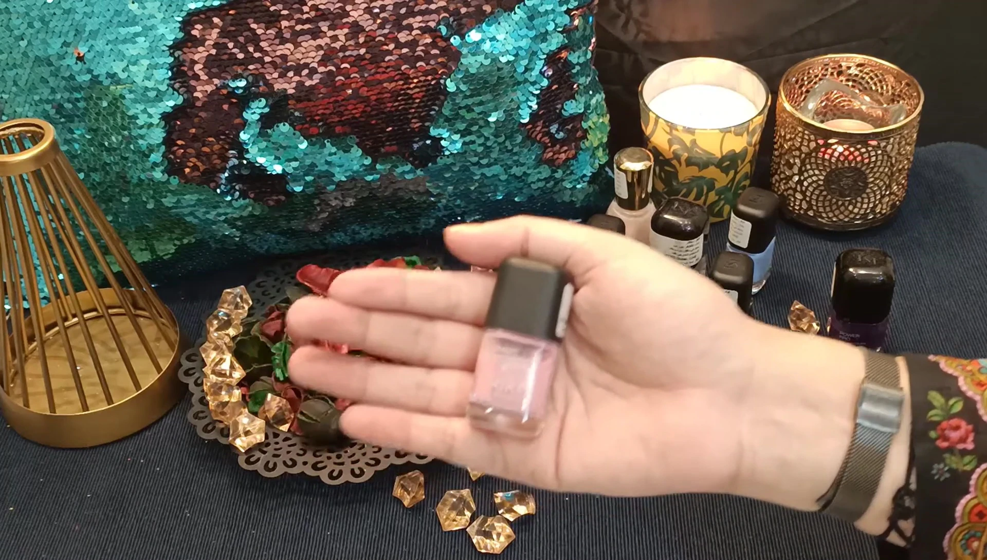 Close-up of the light pink nail polish with silver glitter.
