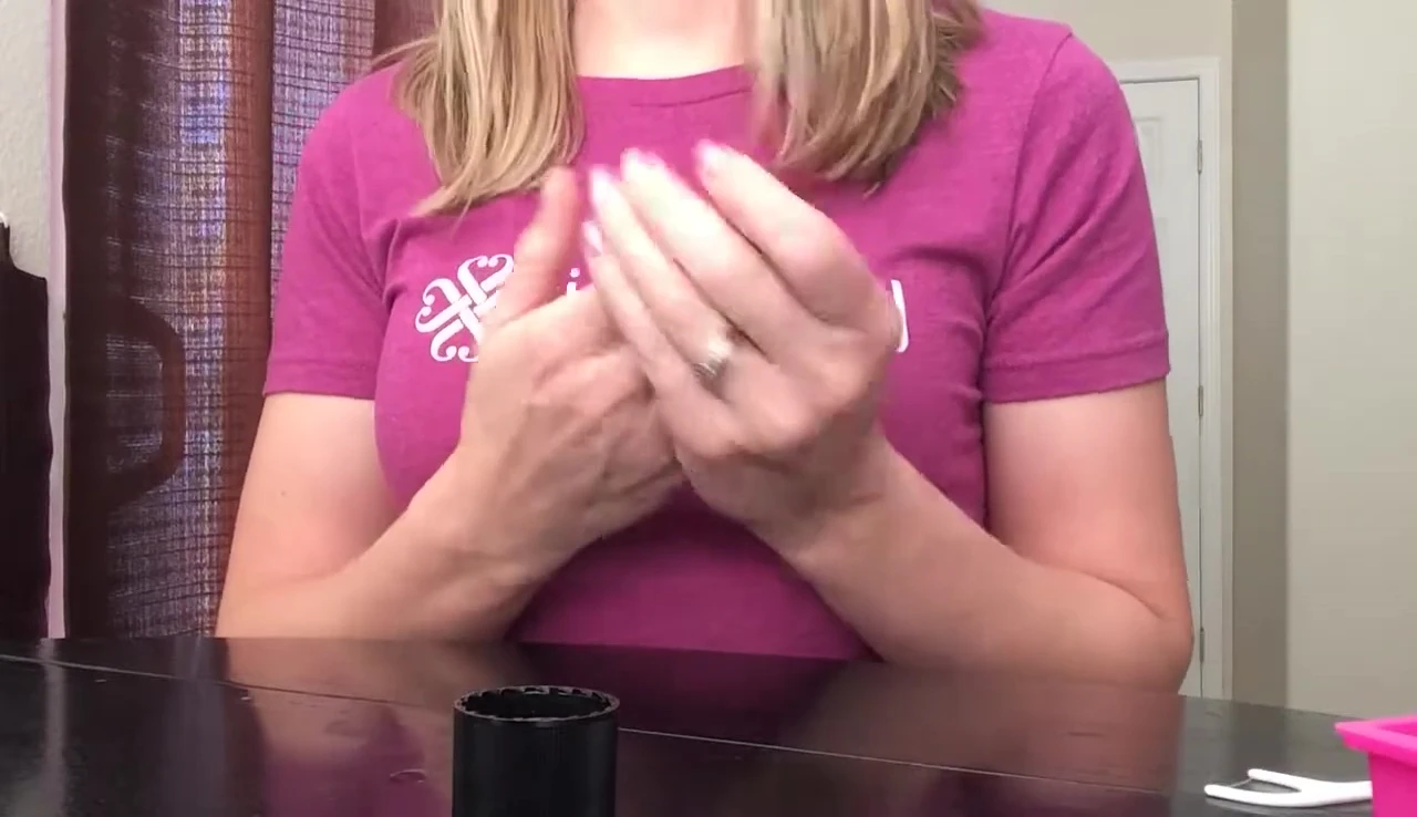 Applying lotion to moisturize the nails.