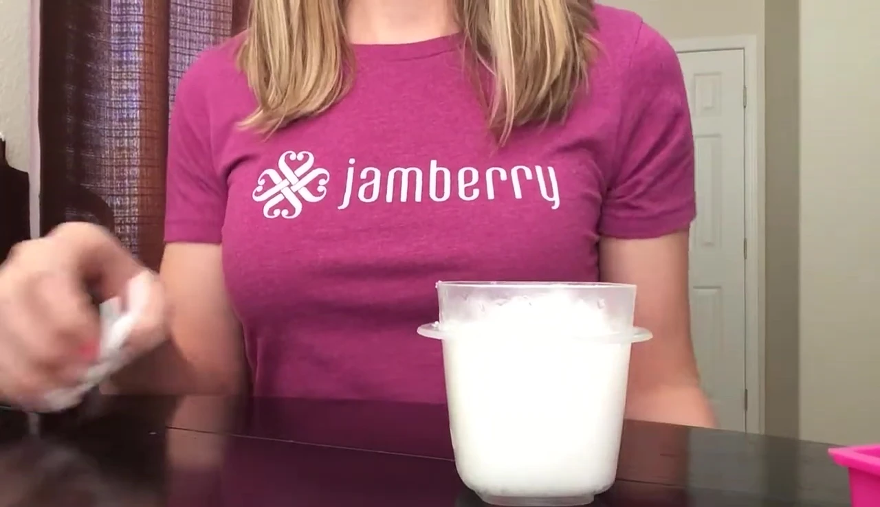 Applying coconut oil around the edges of a Jamberry nail wrap.
