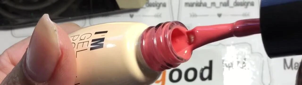 The deep coral color of the polish in its cool state