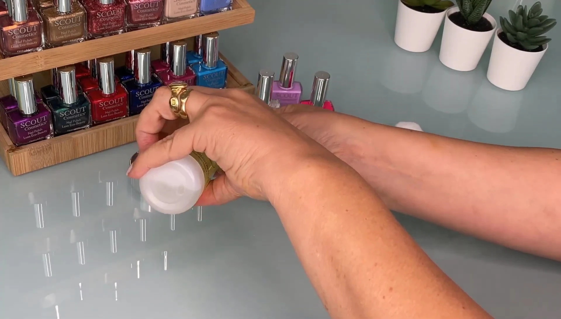 Saturating the cotton bud with the remover.