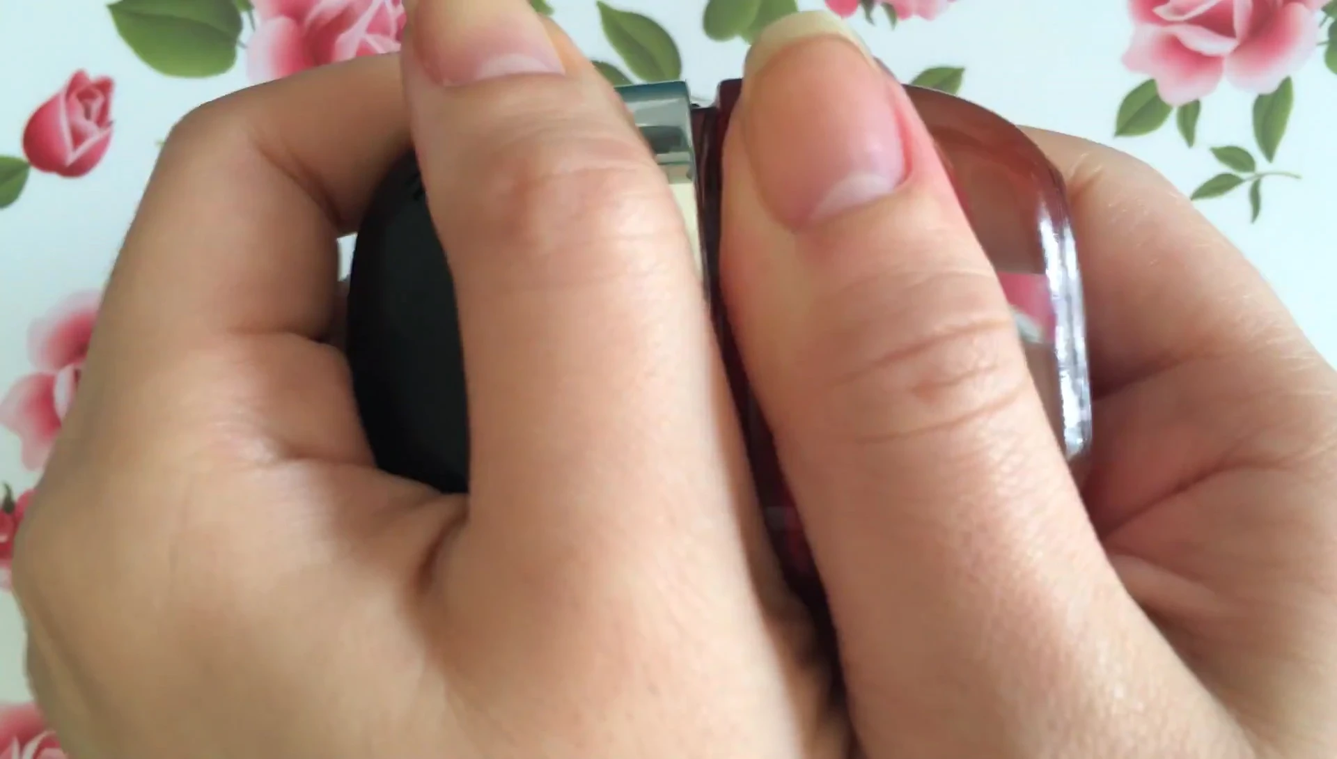 The double-capped design of the nail polish bottle is revealed.