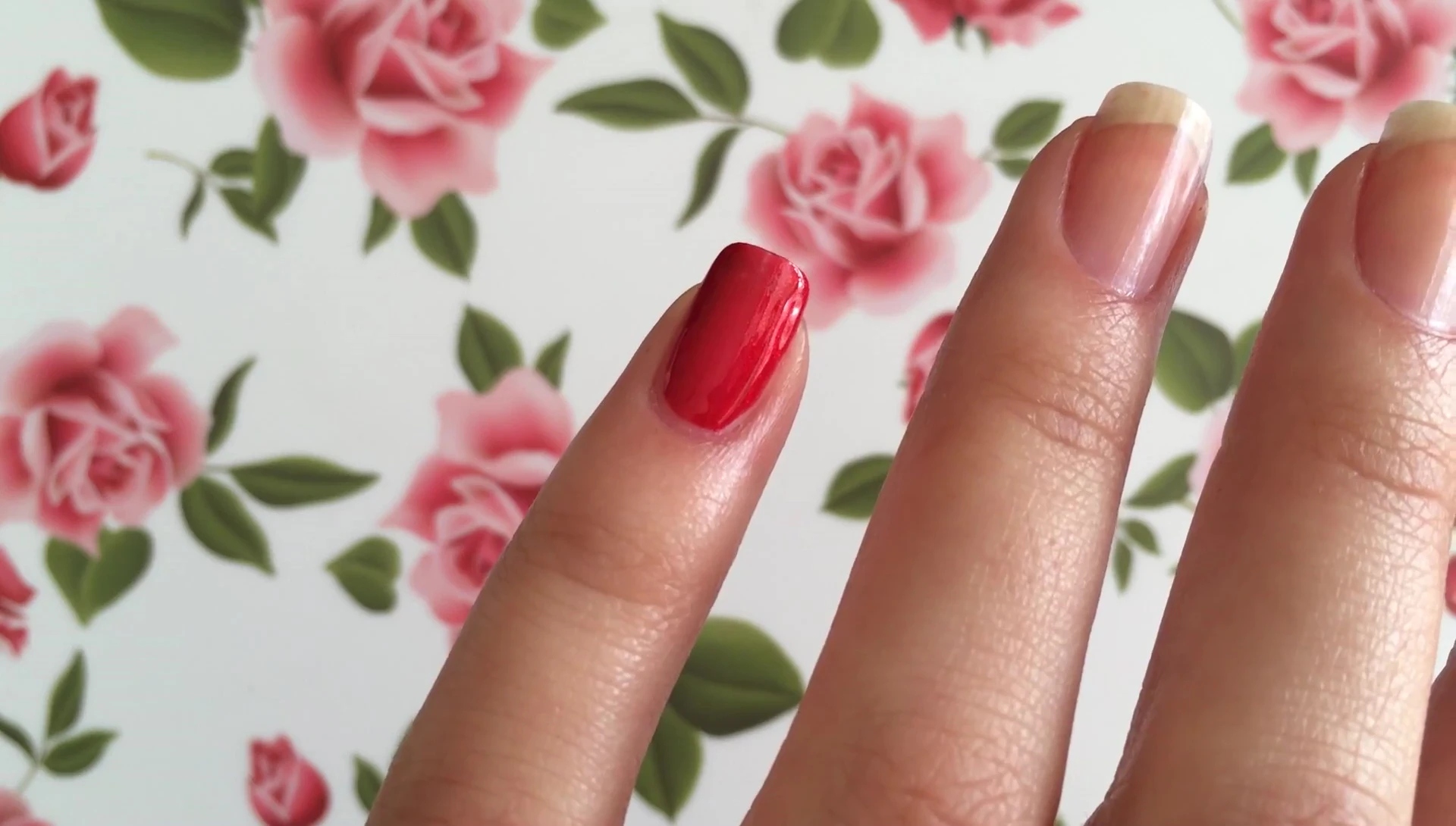 Close-up of Desire nail polish being applied to the pinky finger.