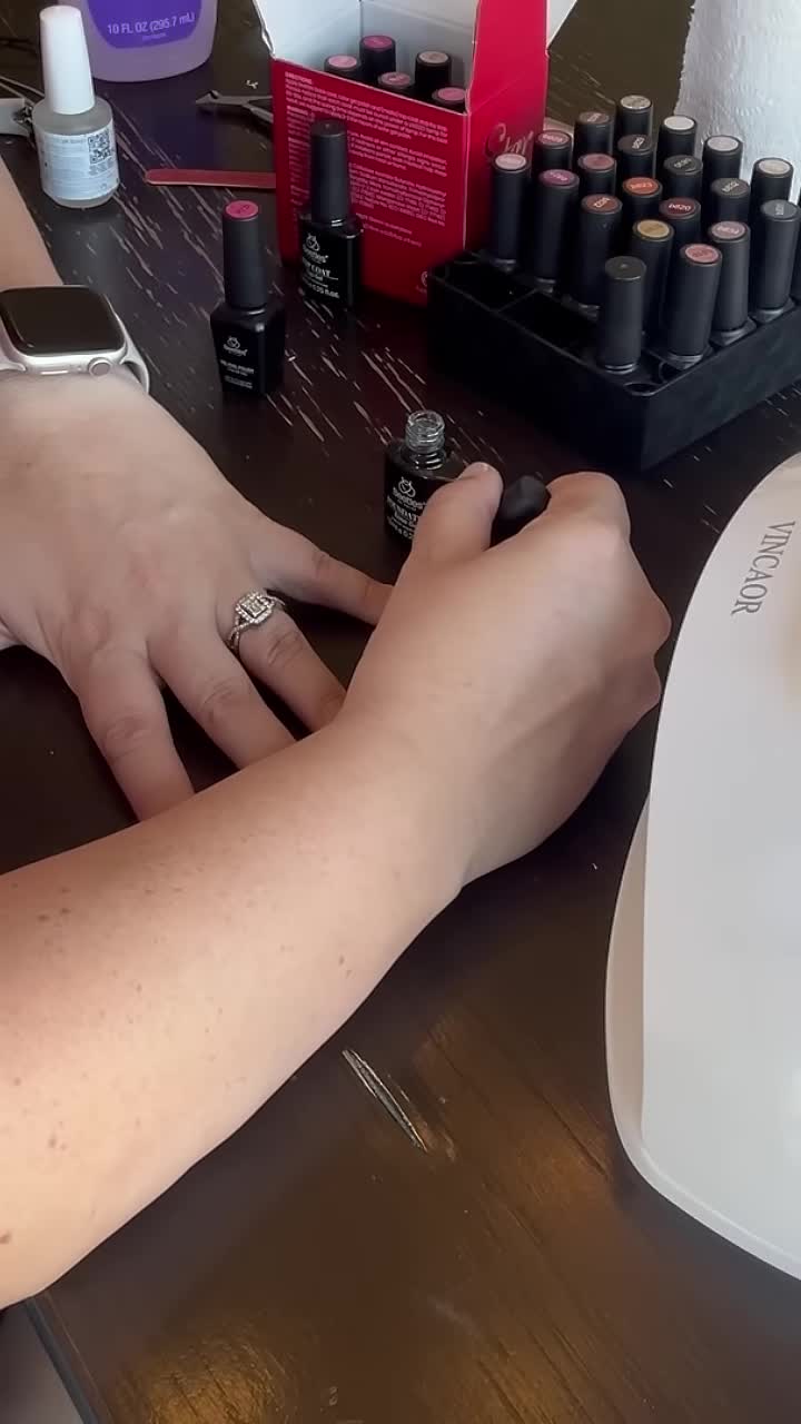 Applying base coat to nails