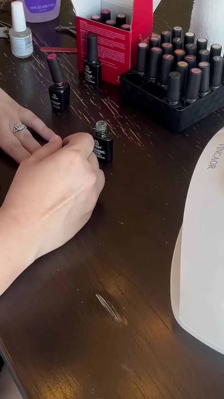 Applying pink gel polish