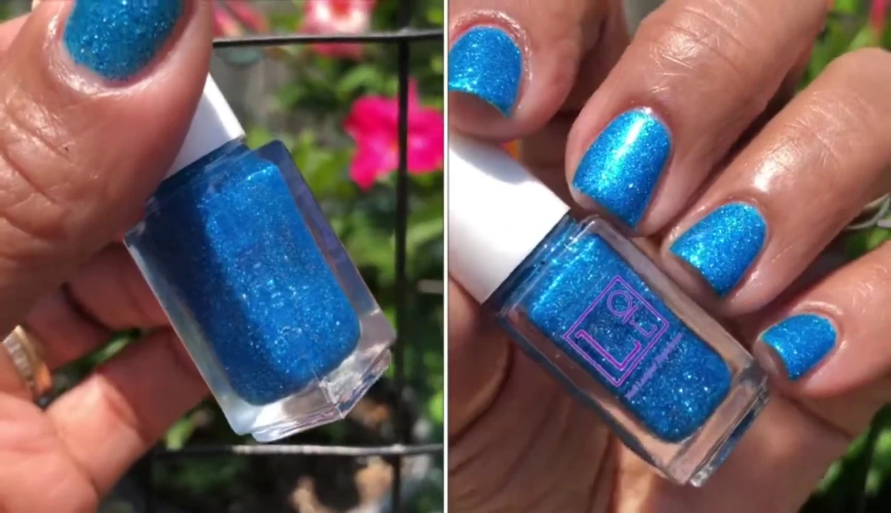 Close-up shot of Finer Things nail polish applied to nails, highlighting its blue glitter.
