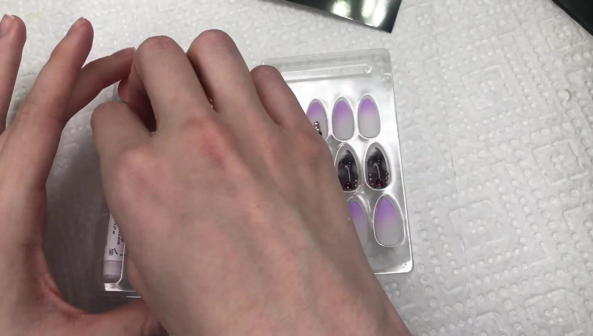 The zip-lock bag containing extra press-on nails