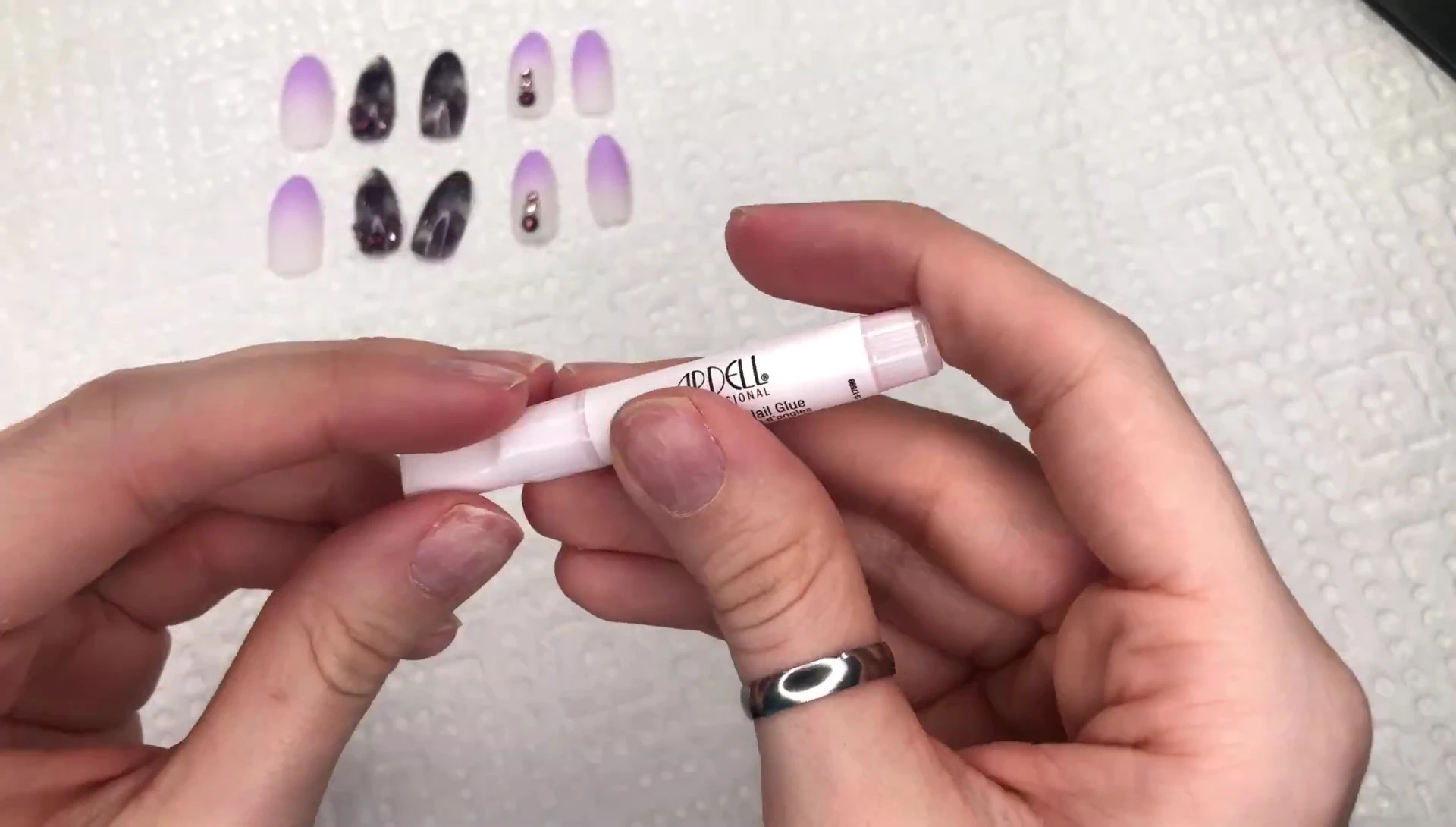 Applying glue and pressing on the press-on nails