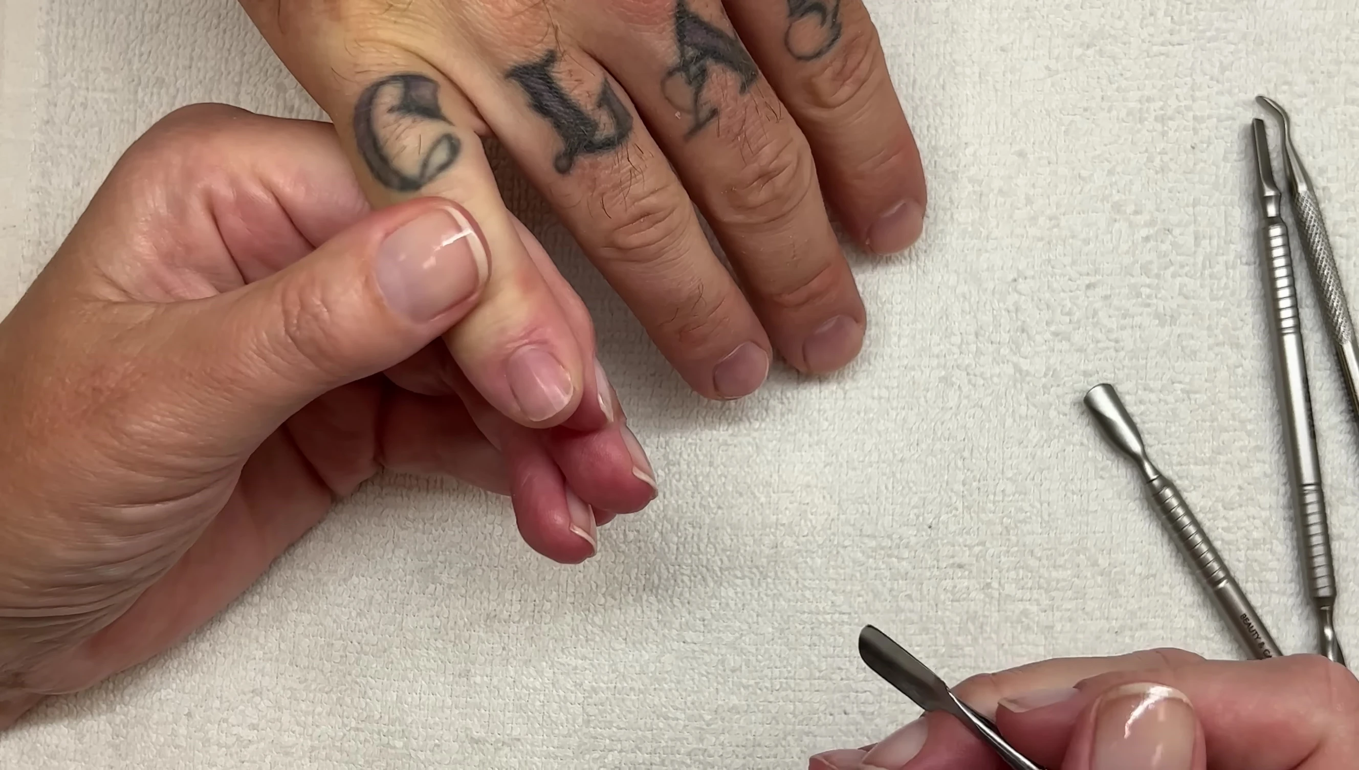 The reviewer demonstrating the use of the Manucurist pusher on a nail.