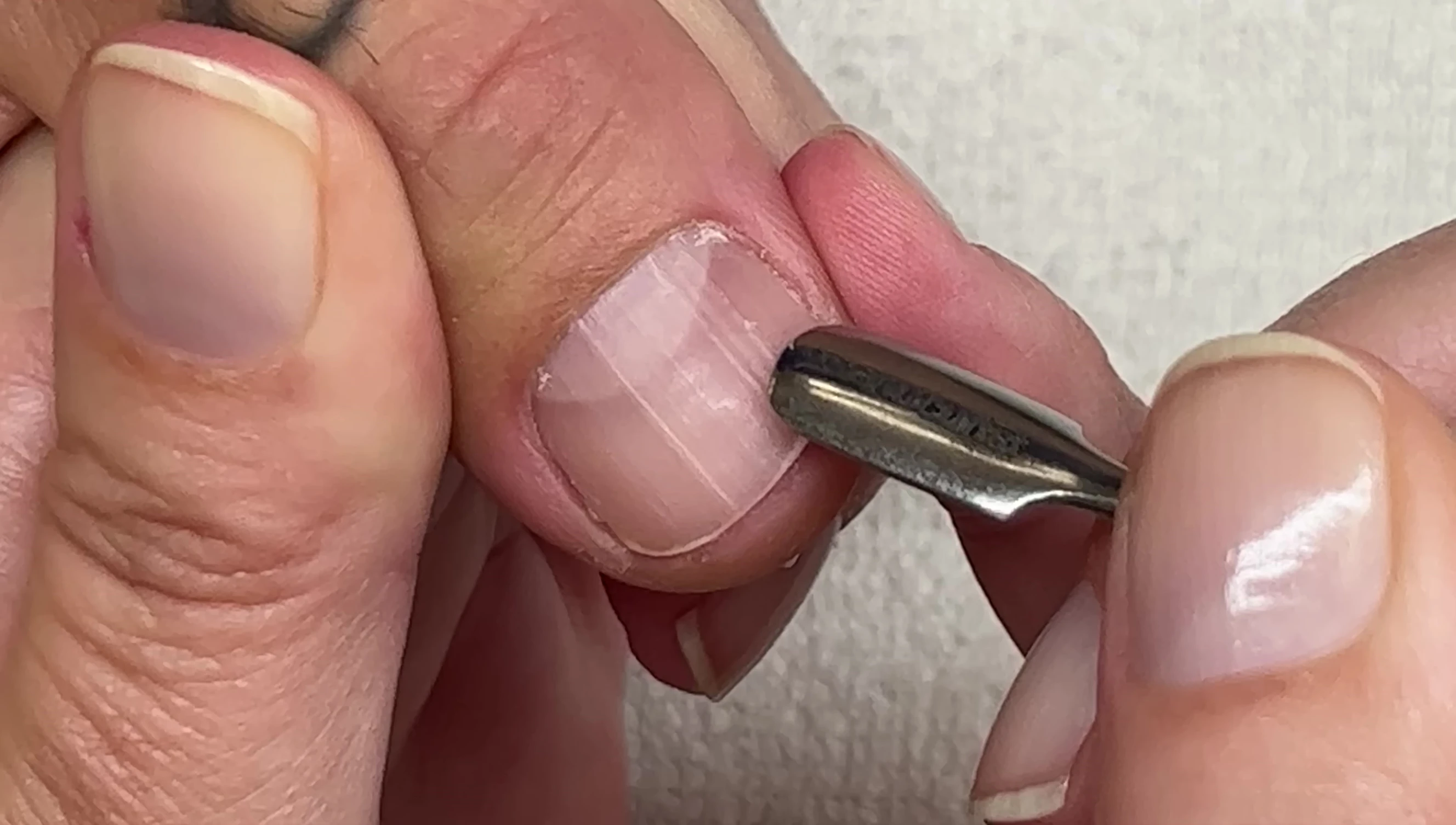 Close-up of a nail showing a scratch from the tool.