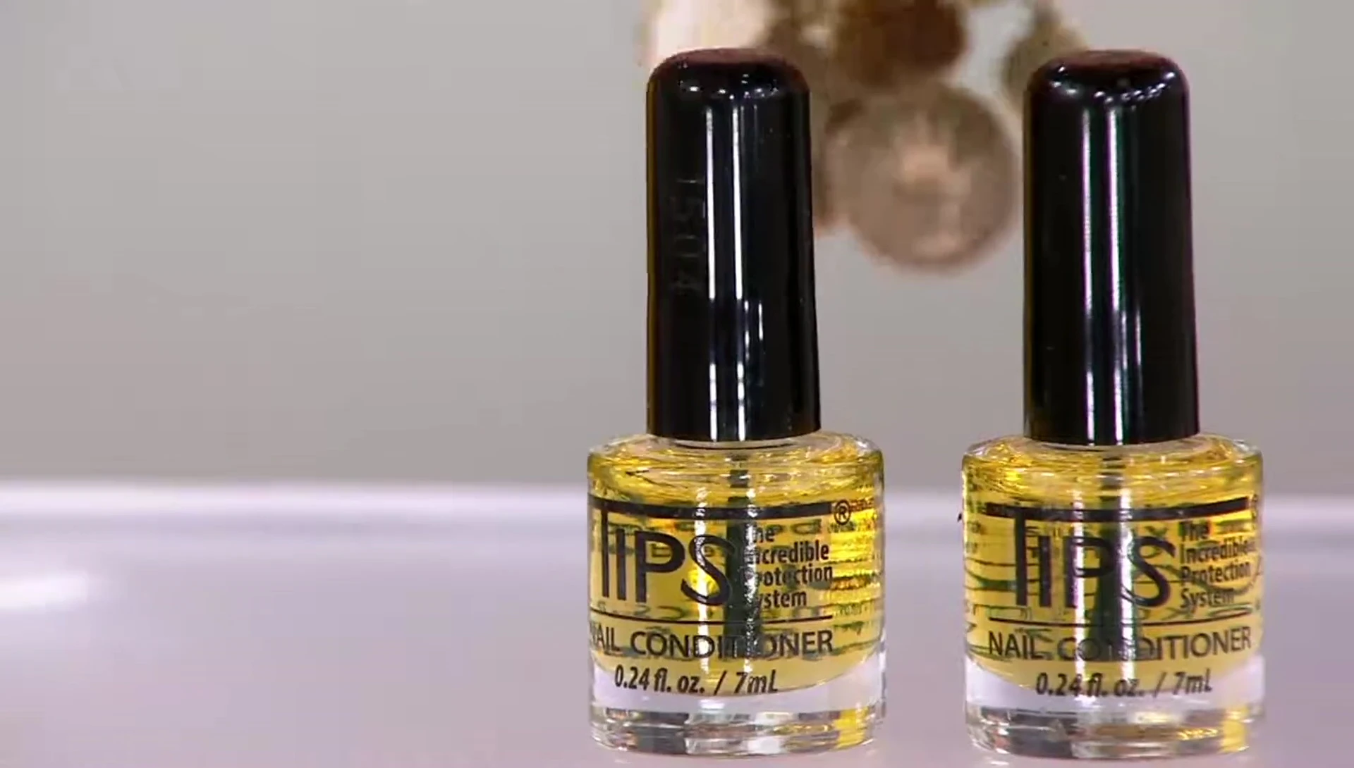Close-up of the two-bottle set of T.I.P.S. Nail Strengthening Conditioner
