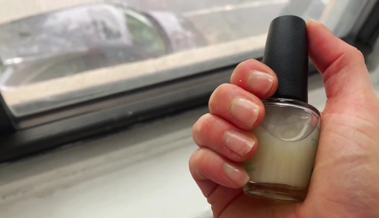 Applying the third coat of OPI Nail Envy.