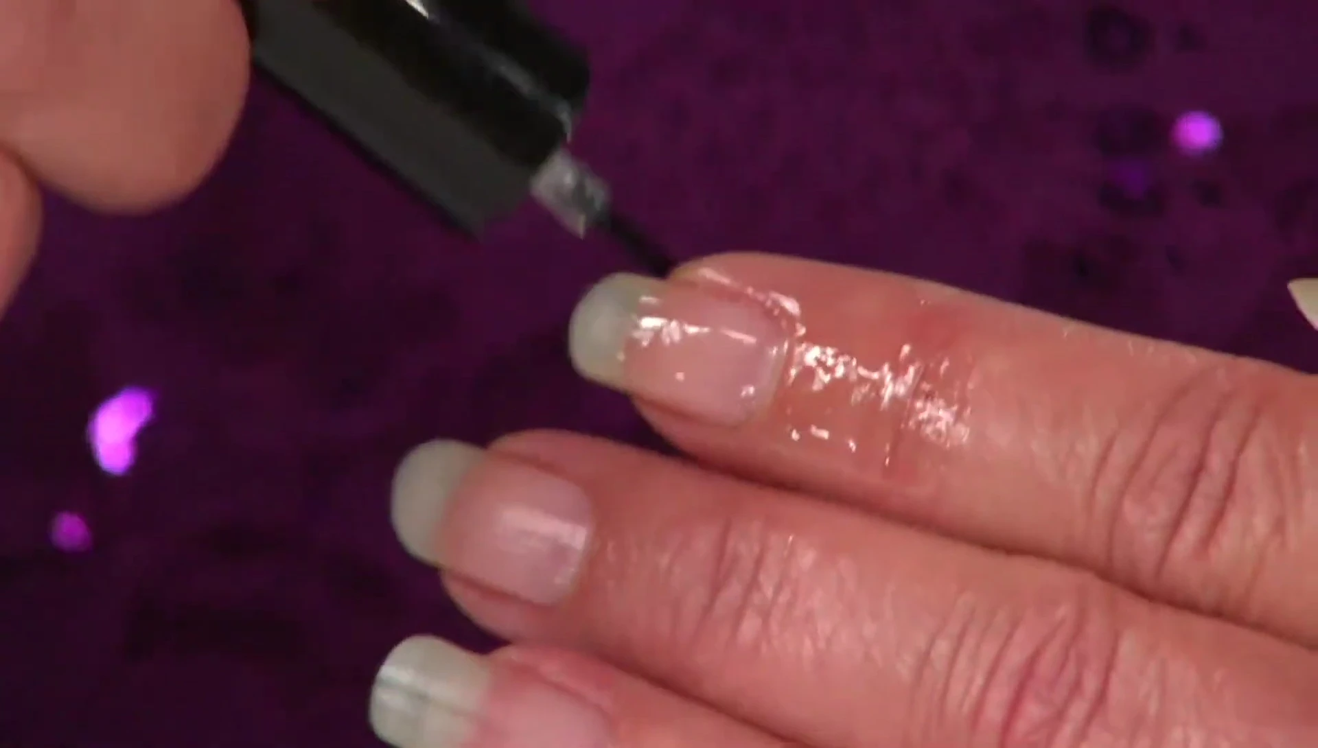 Presenter explaining the role of lipids in nail health and strength.