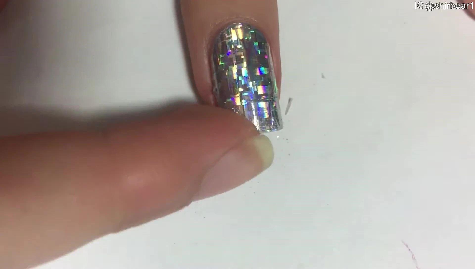 Finished nails with the nail stickers applied and top coat added.