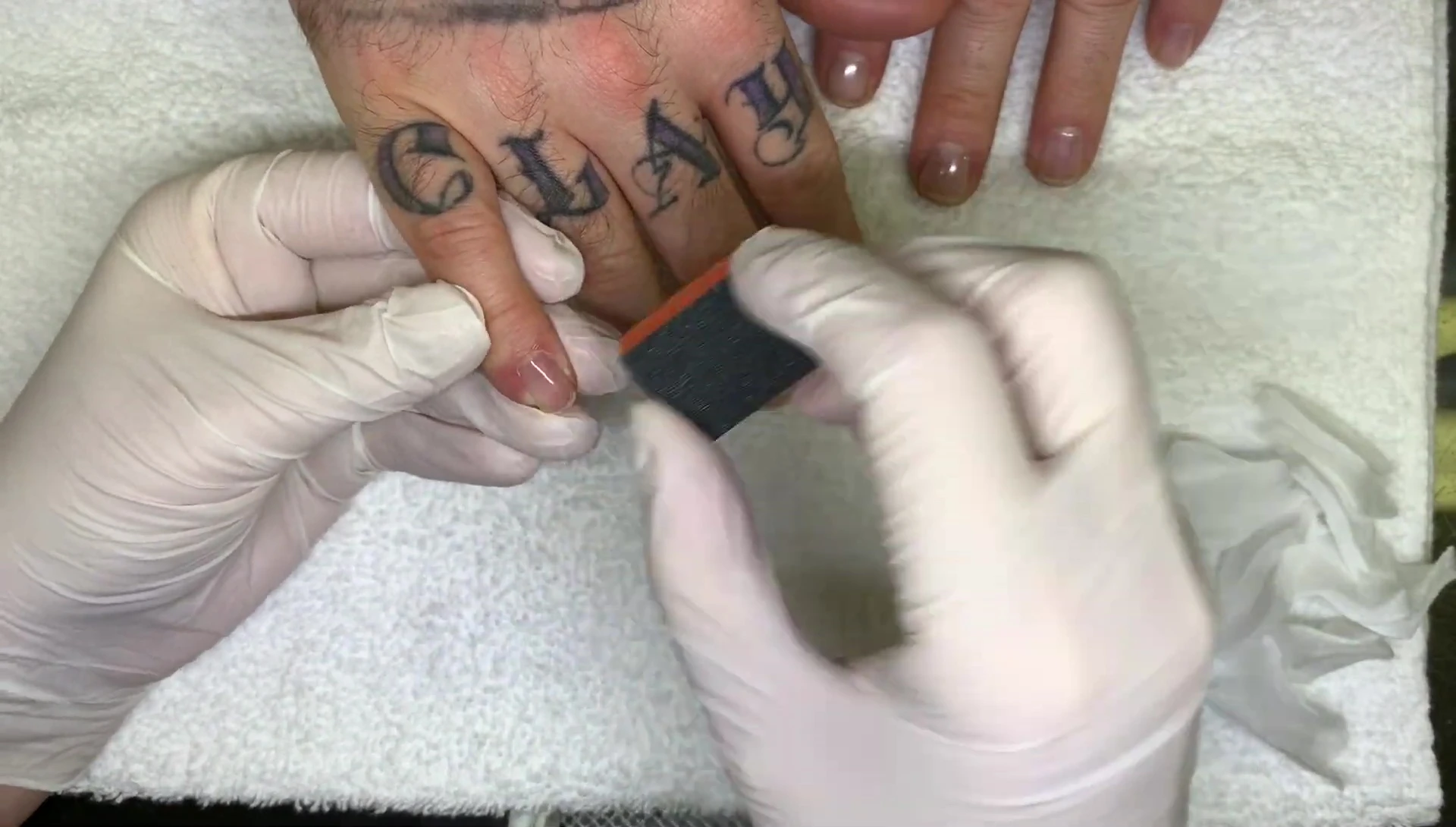 The speaker is showing the thin application on nails.