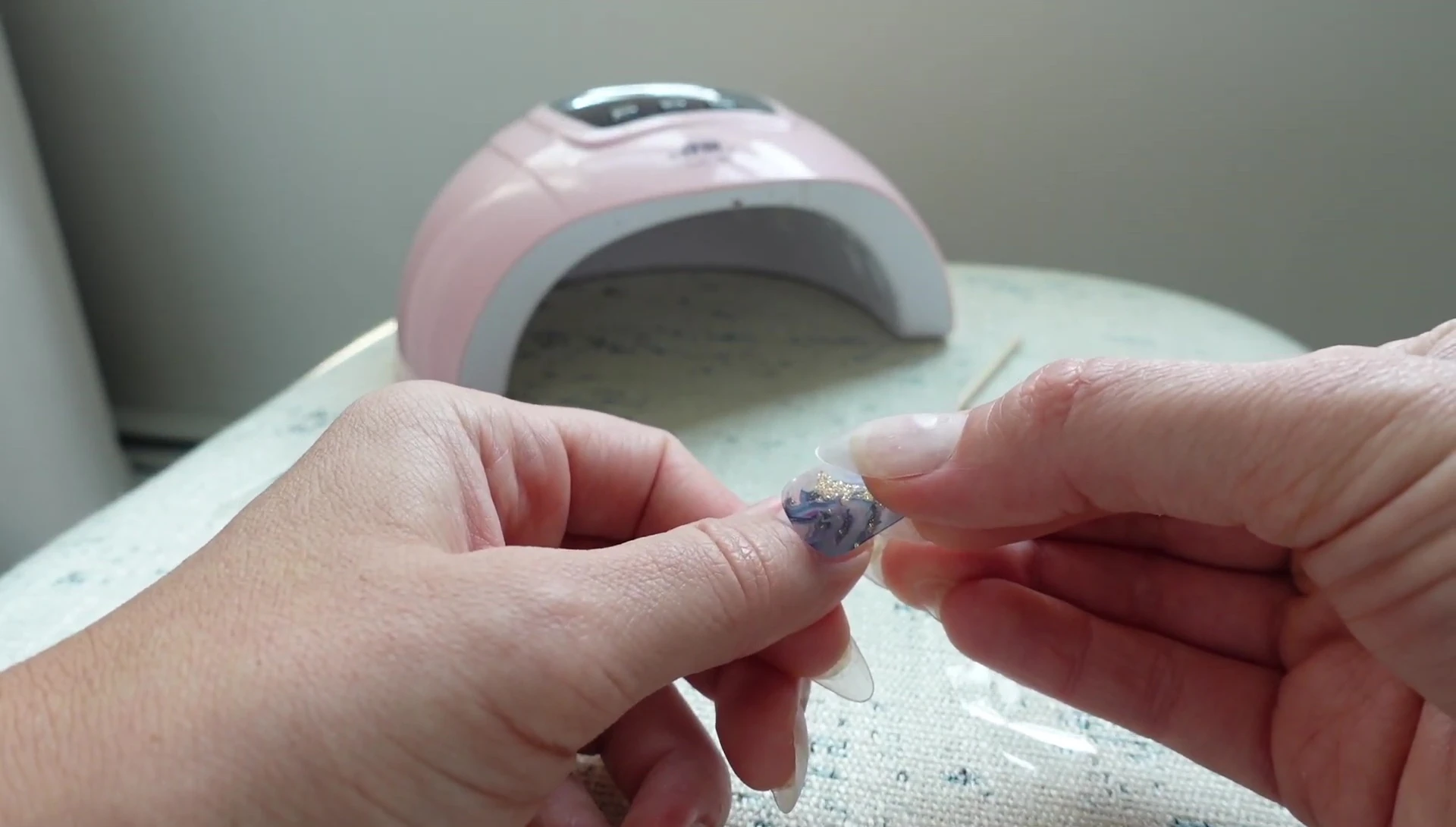 Applying the nail sticker to the nail.