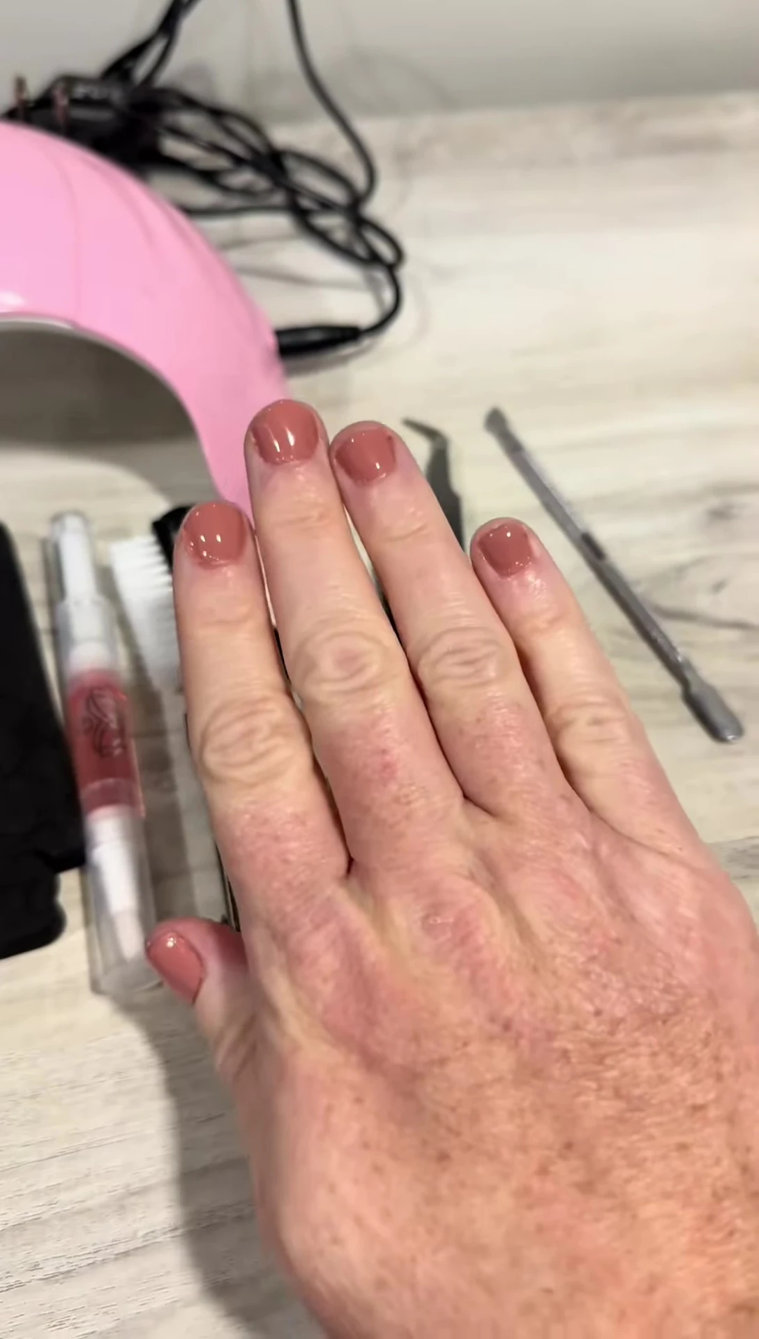 Close-up shot of the reviewer's hands showing off the manicure