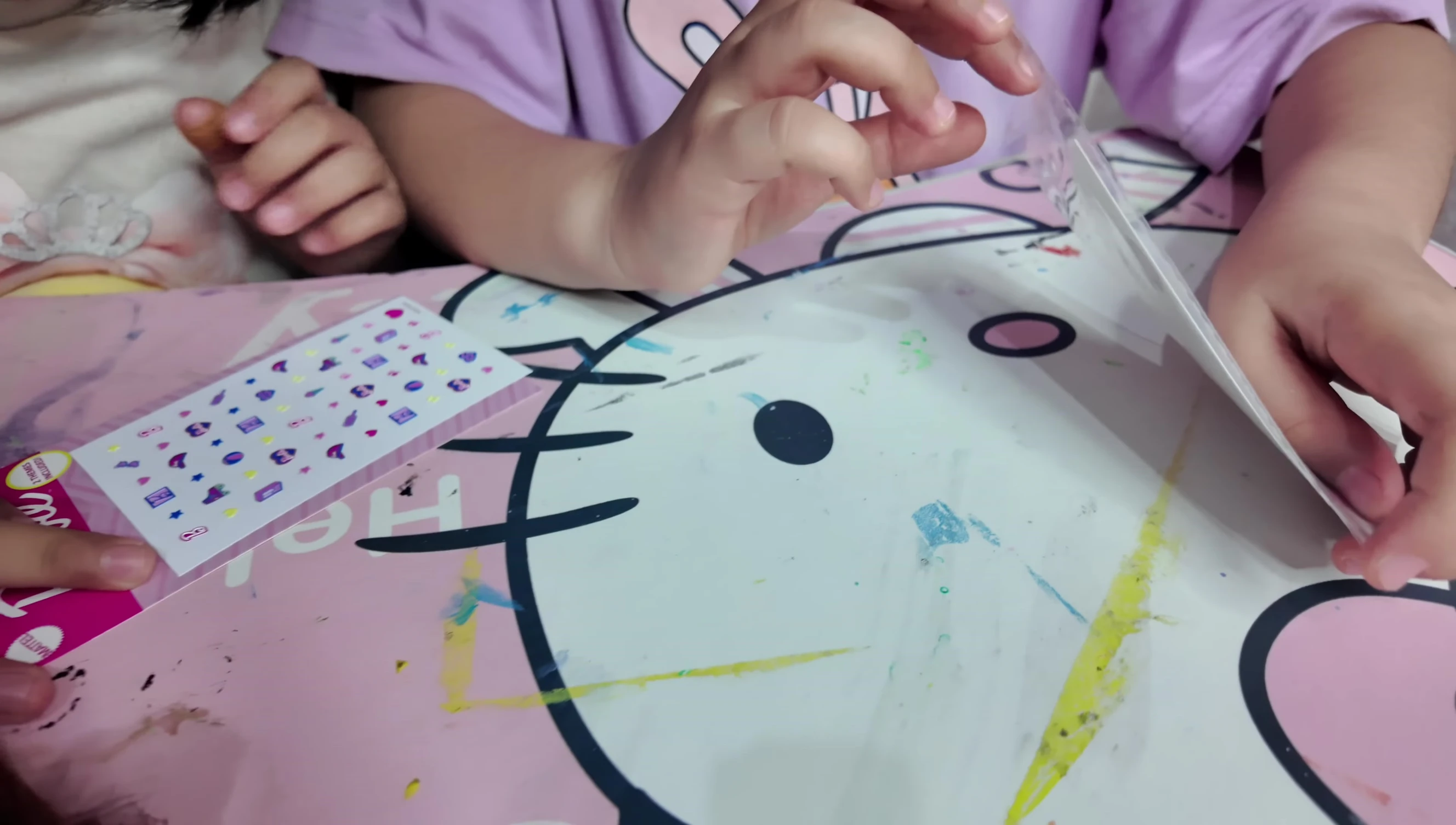 Close-up of the girls applying nail art stickers on their nails