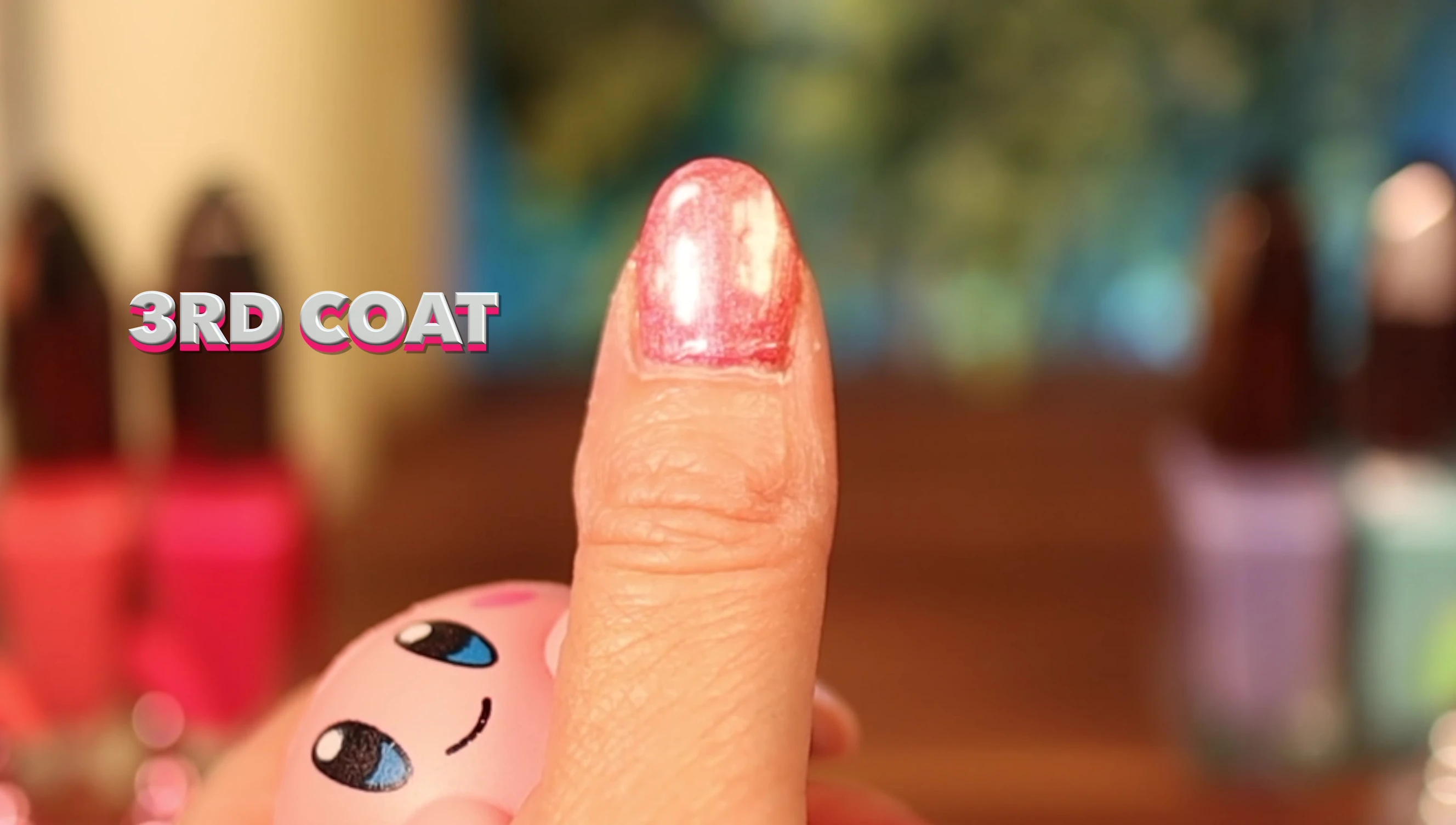 Momo Yuyaki on a nail extension, highlighting the orange shimmer and overall vibrancy.