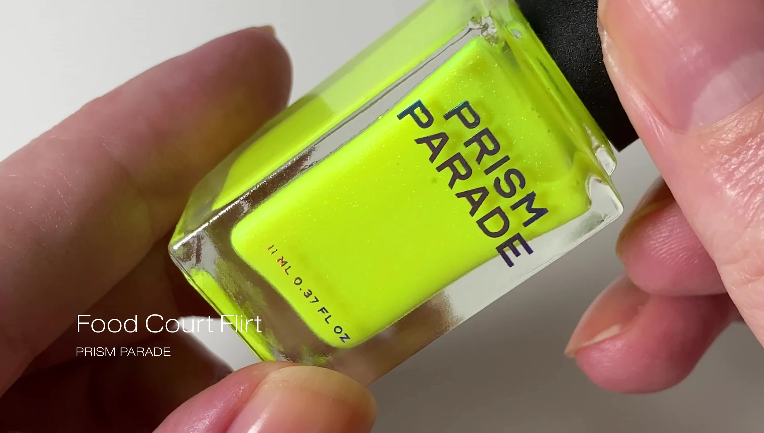 Close-up of Food Court Flirt nail polish, showing the neon yellow color and green shimmer.
