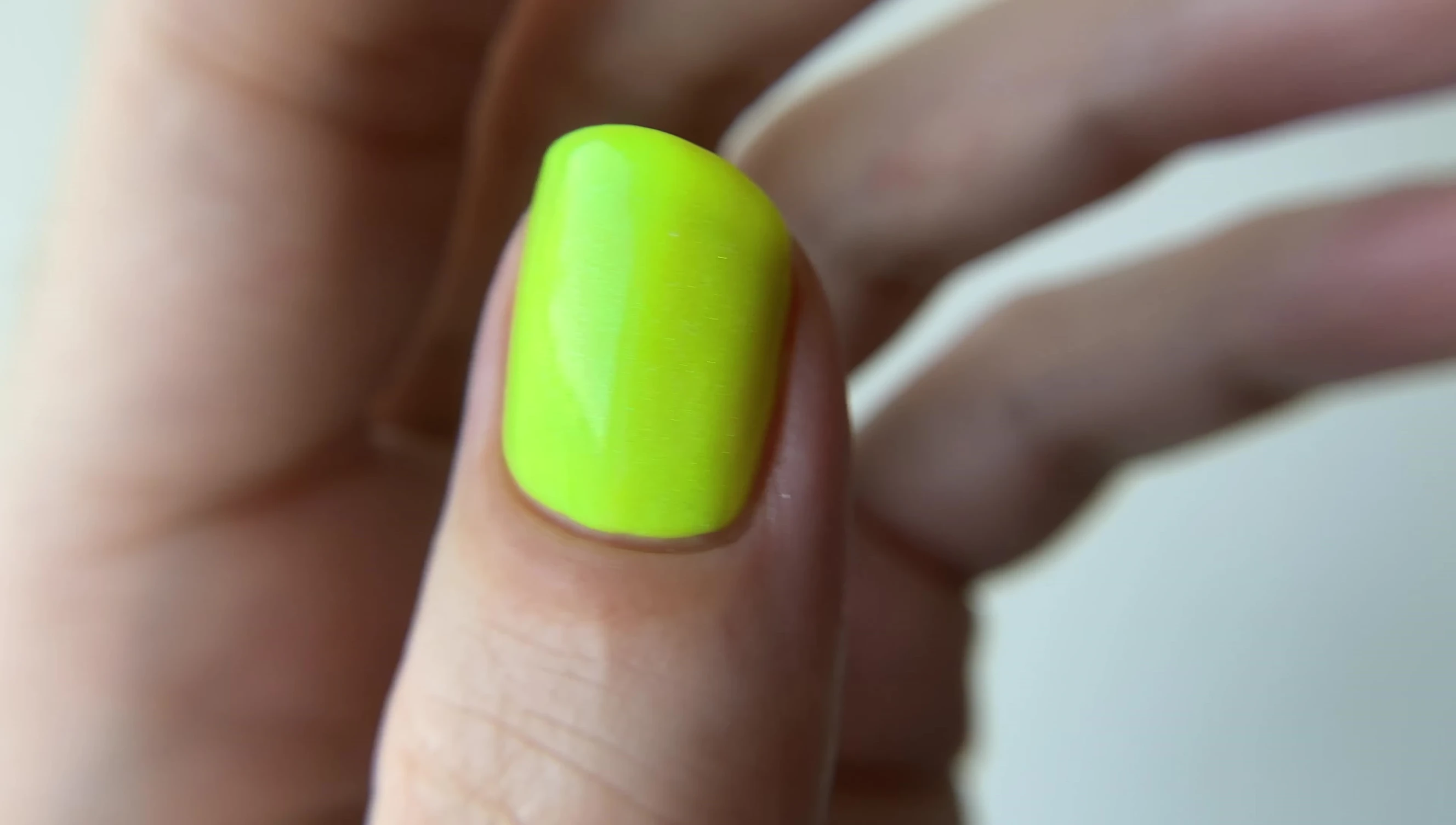 Food Court Flirt nail polish under UV light, highlighting its green glow.
