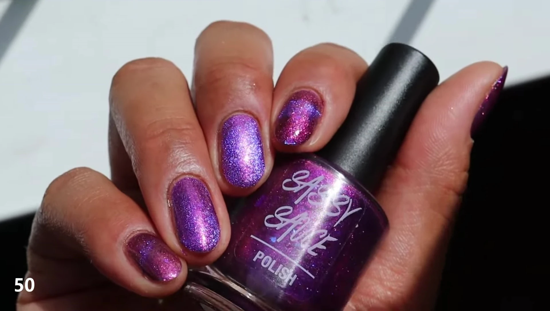 Swatches of '50' nail polish with glossy top coat and different magnetic effects