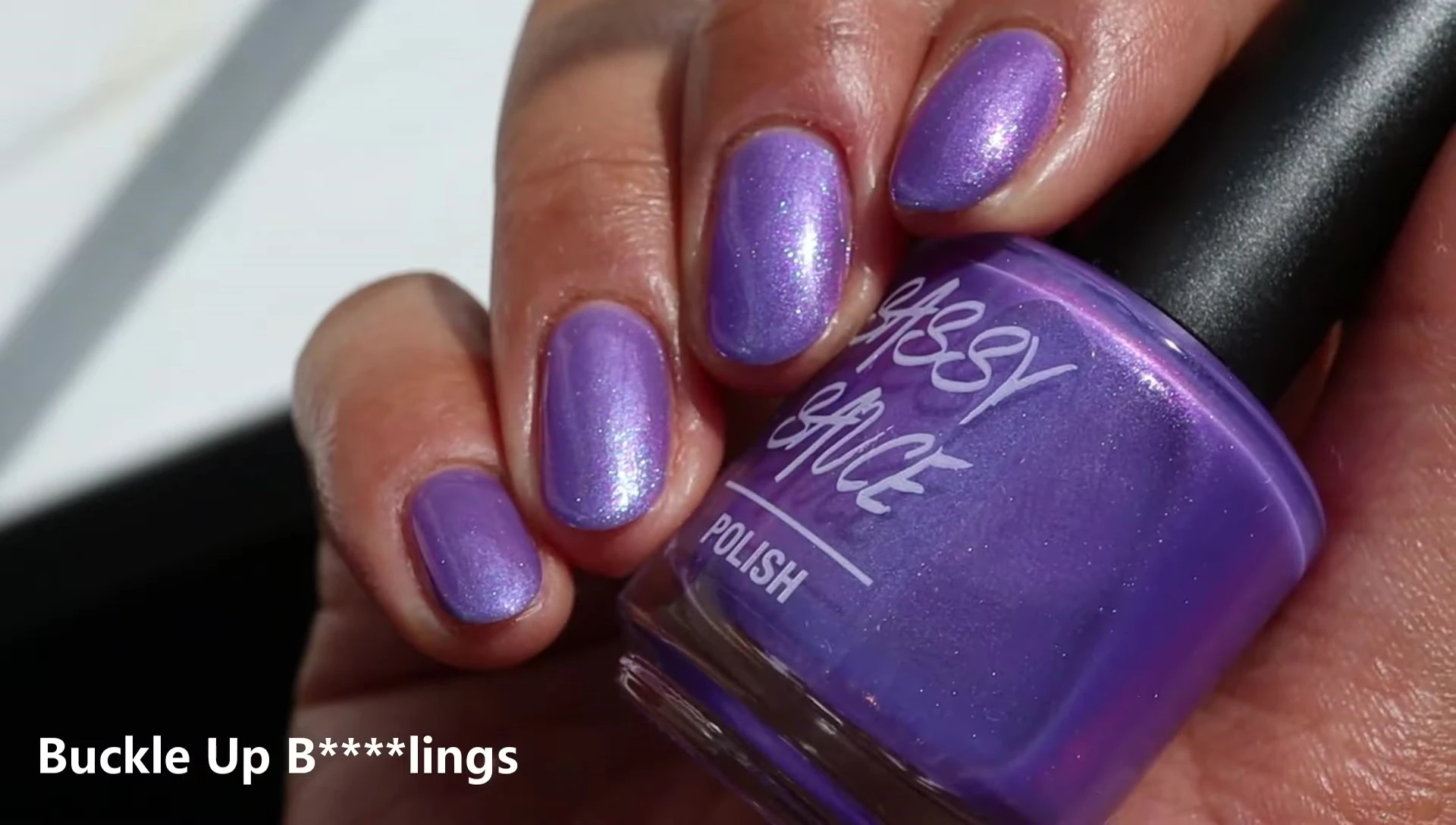 Swatches of Buckle Up nail polish on nails with a glossy top coat