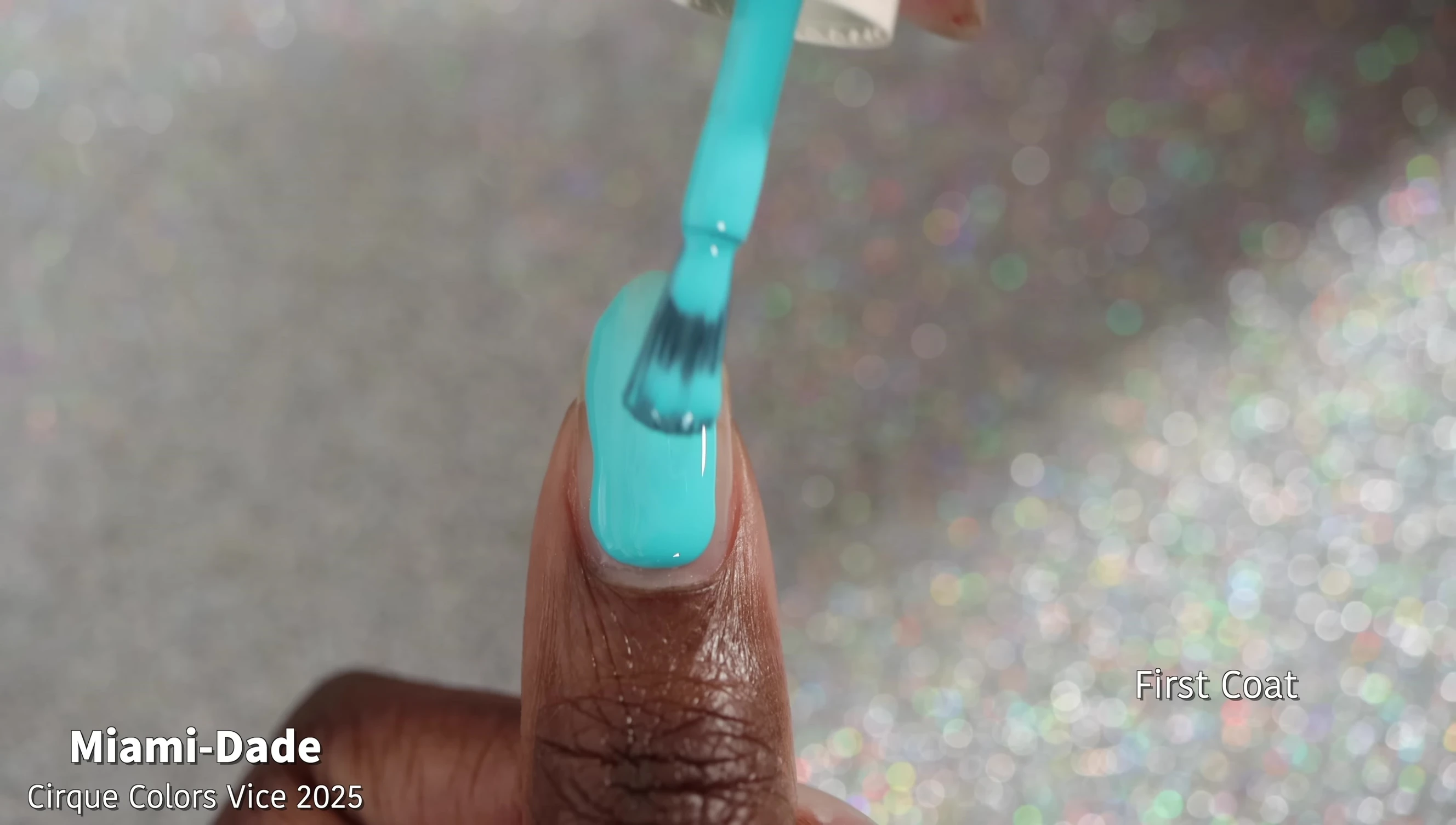 Close-up shot of Miami Dade nail polish on nails