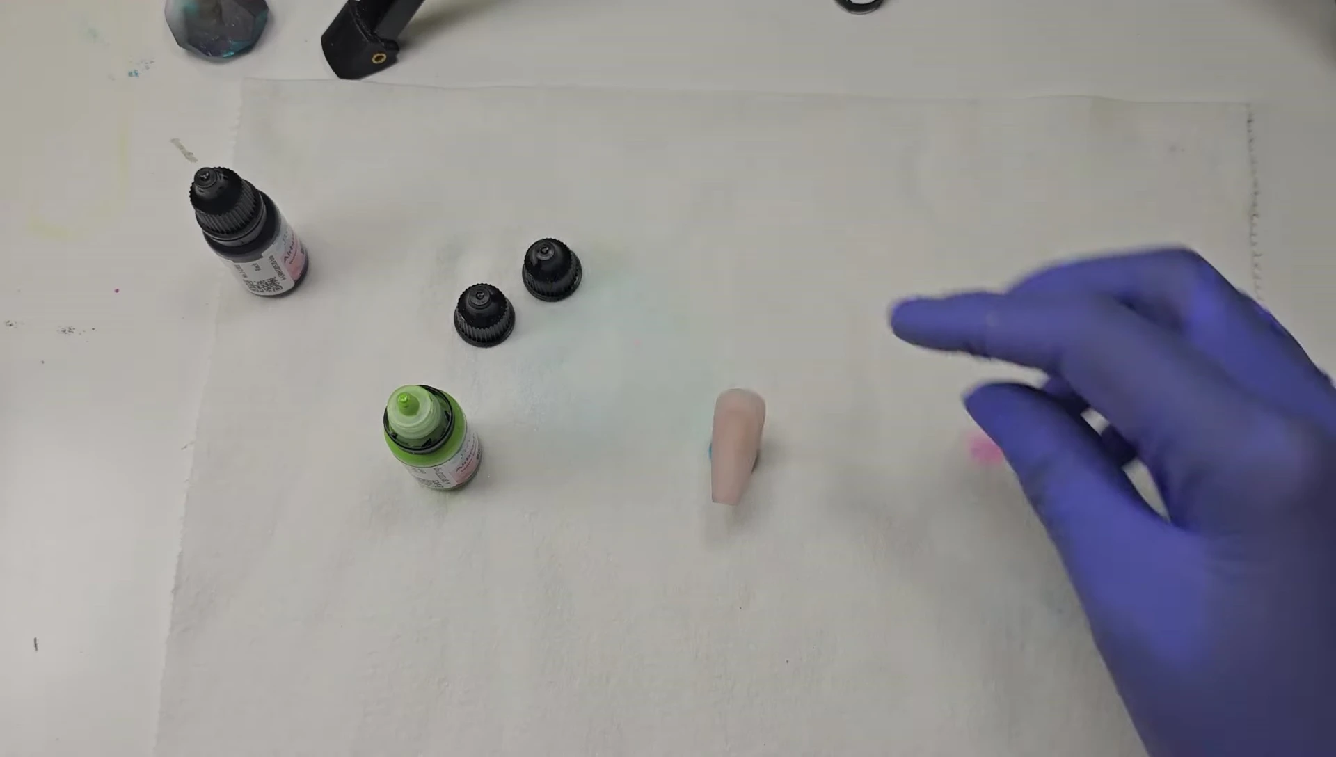 The airbrush application technique being demonstrated.