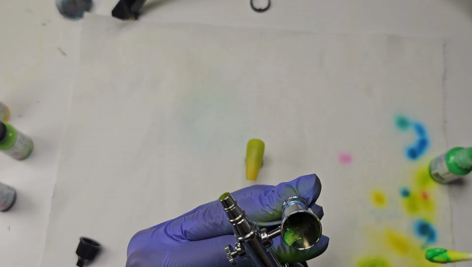 The thicker neon paint coming out of the airbrush.