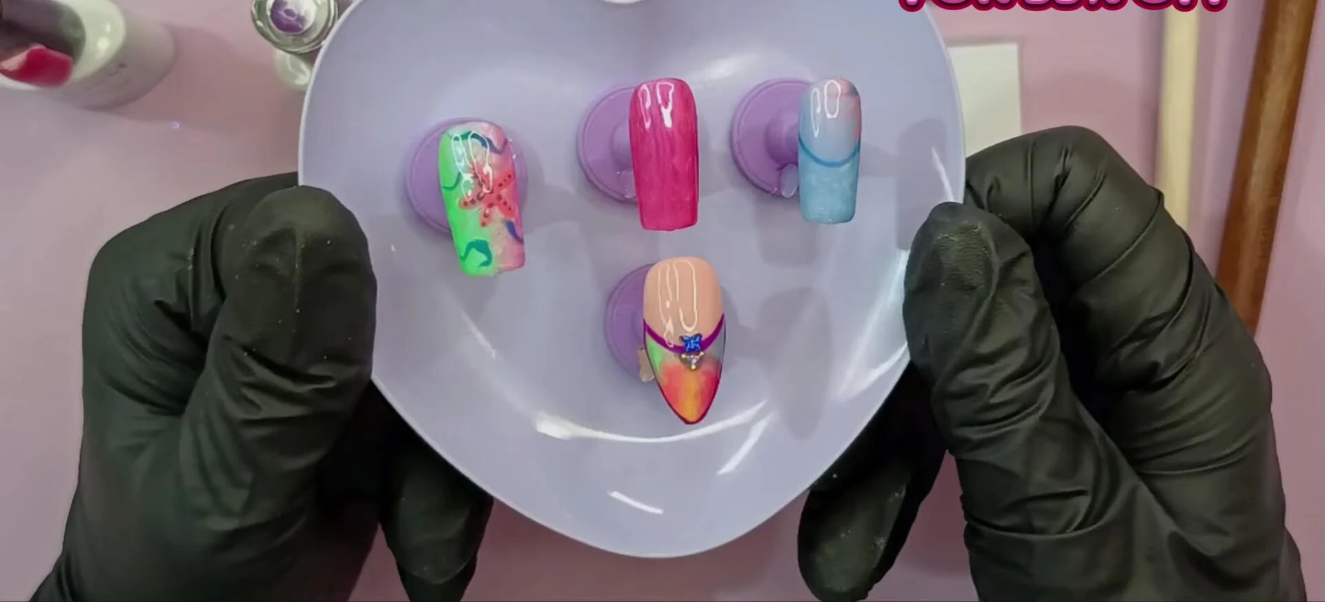 Final shot of the reviewer's hands showcasing multiple nail art designs created with the RARJSM gel polishes