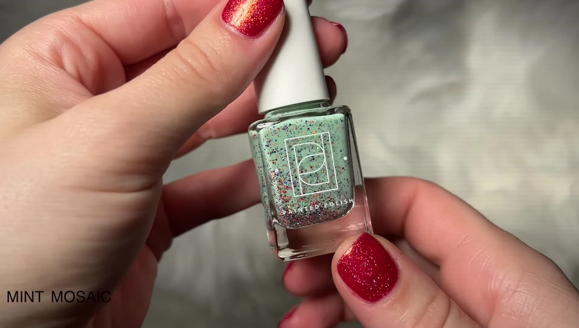 Swatches of Mint Mosaic, demonstrating the rainbow glitter and minty base