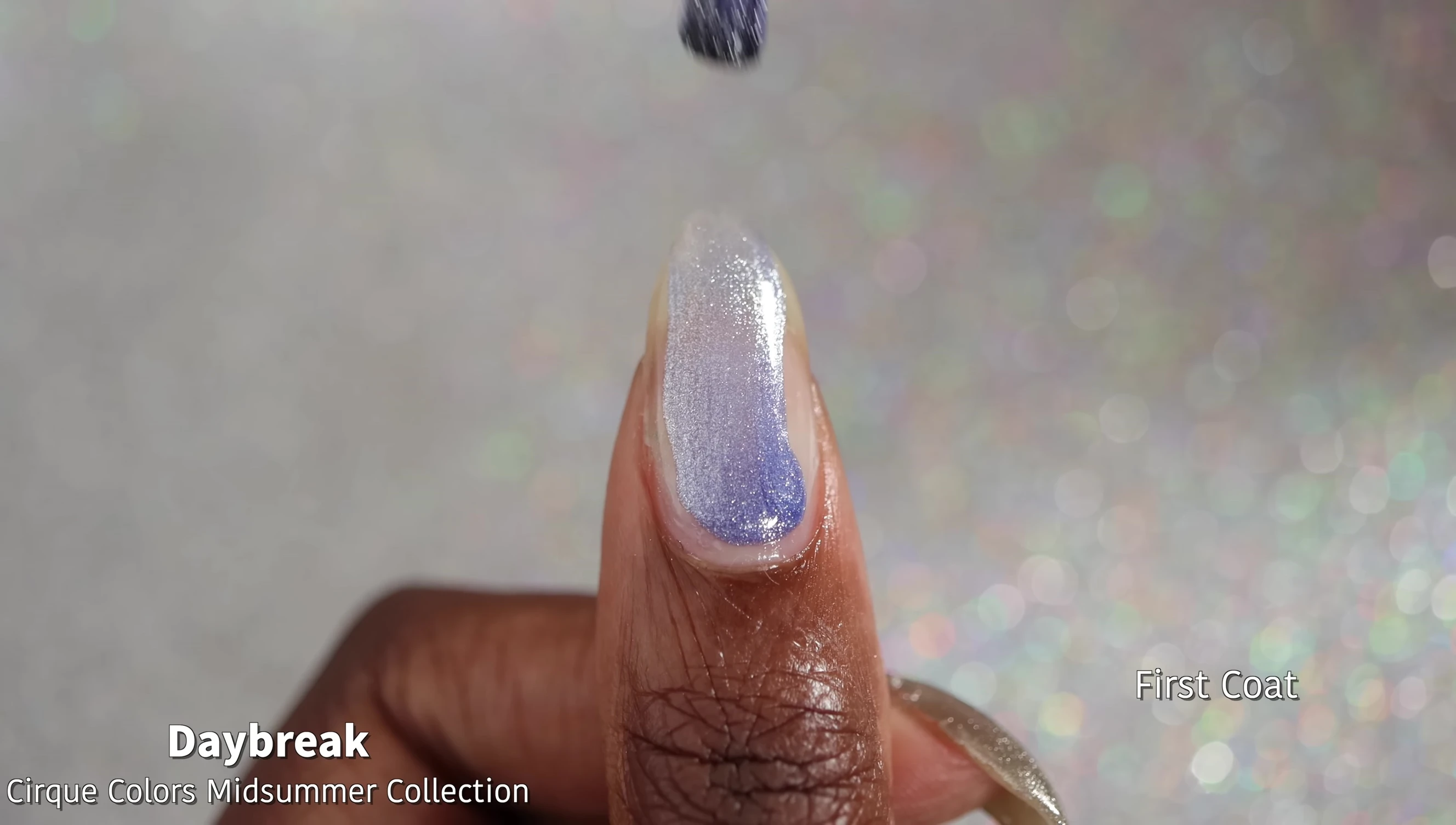Close-up of Daybreak nail polish bottle and swatch.