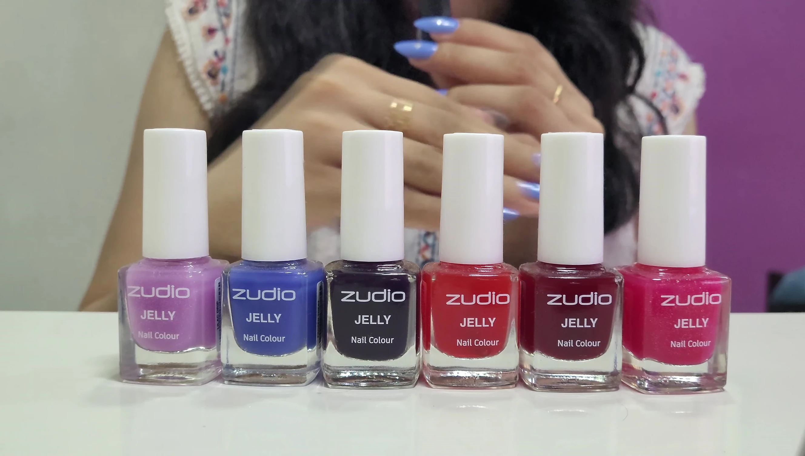 Hands showing drying nail polish.