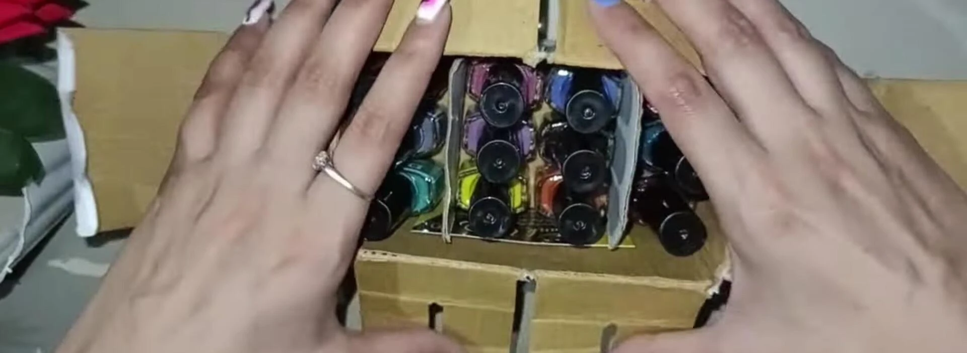 The box being opened, revealing the nail polish set.