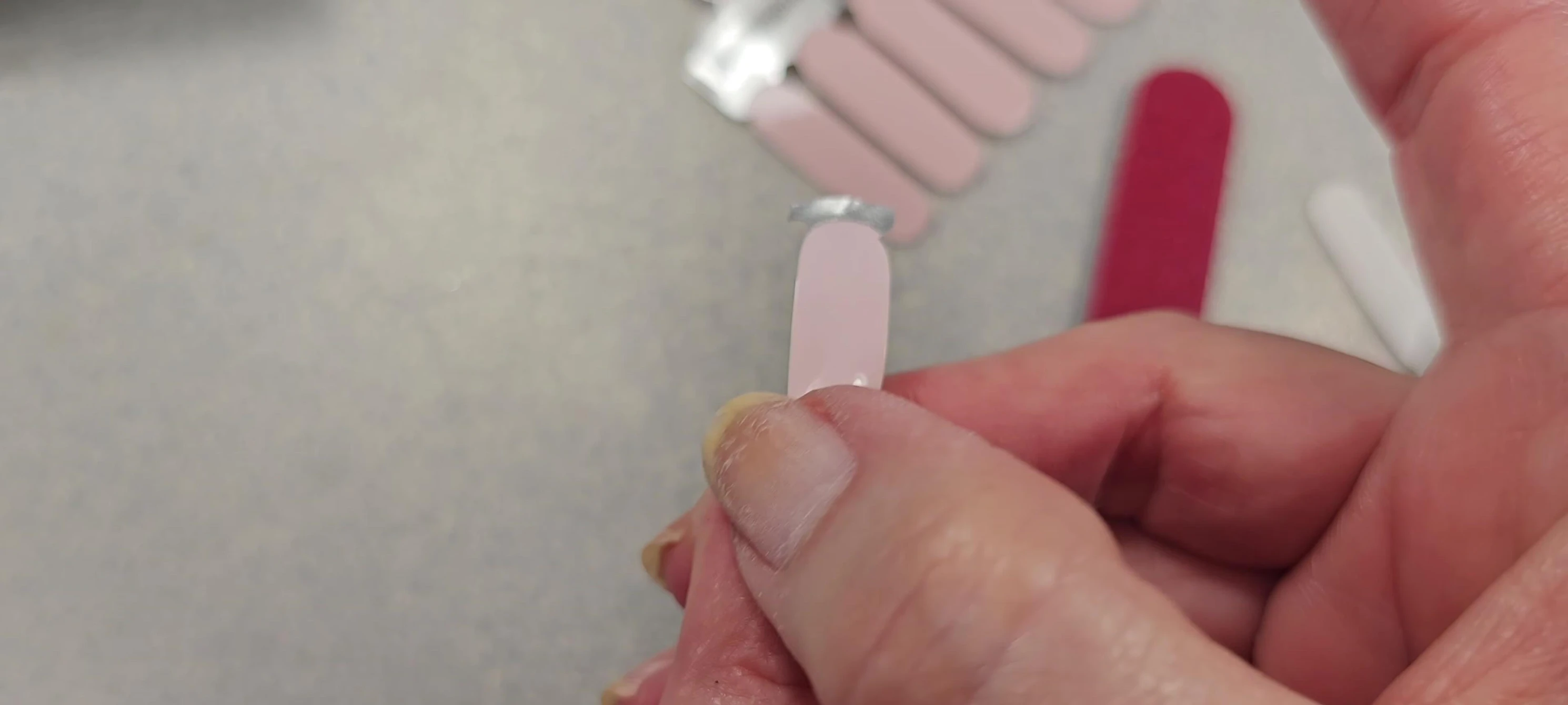 Applying and filing the nail strip