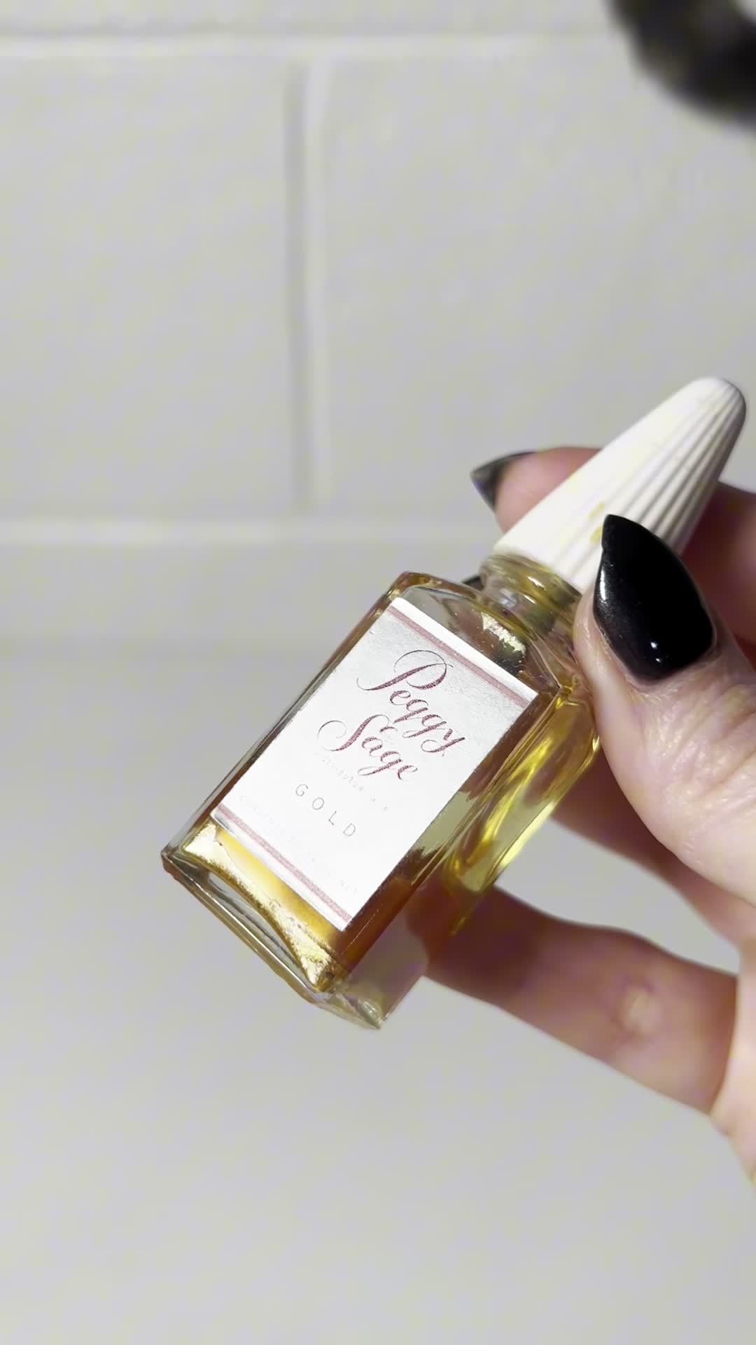 The nail polish bottle being carefully opened