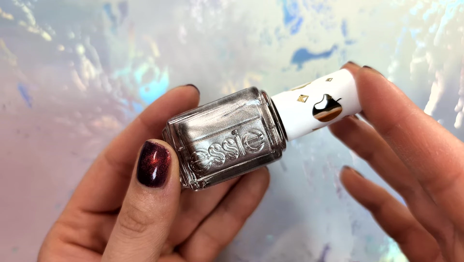 Hand model showcasing the slightly streaky silver foil polish.