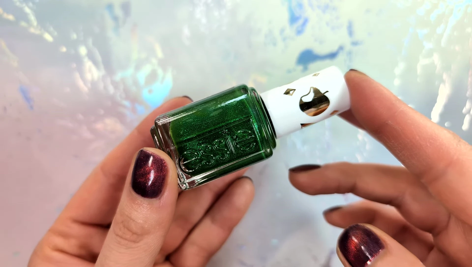 Hand model showcasing the emerald green nail polish on her nails.