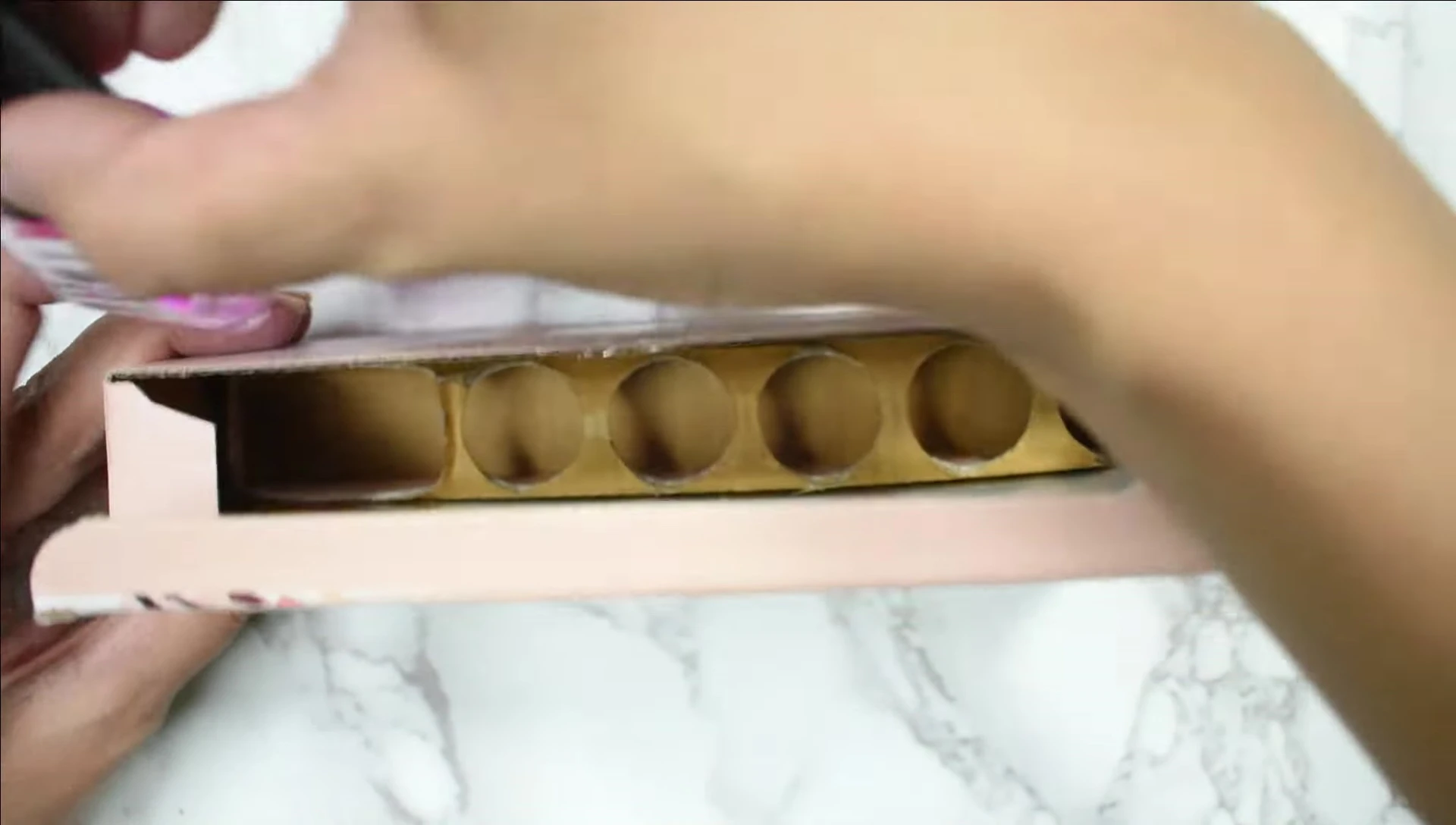 All five nail polish shades displayed from the box