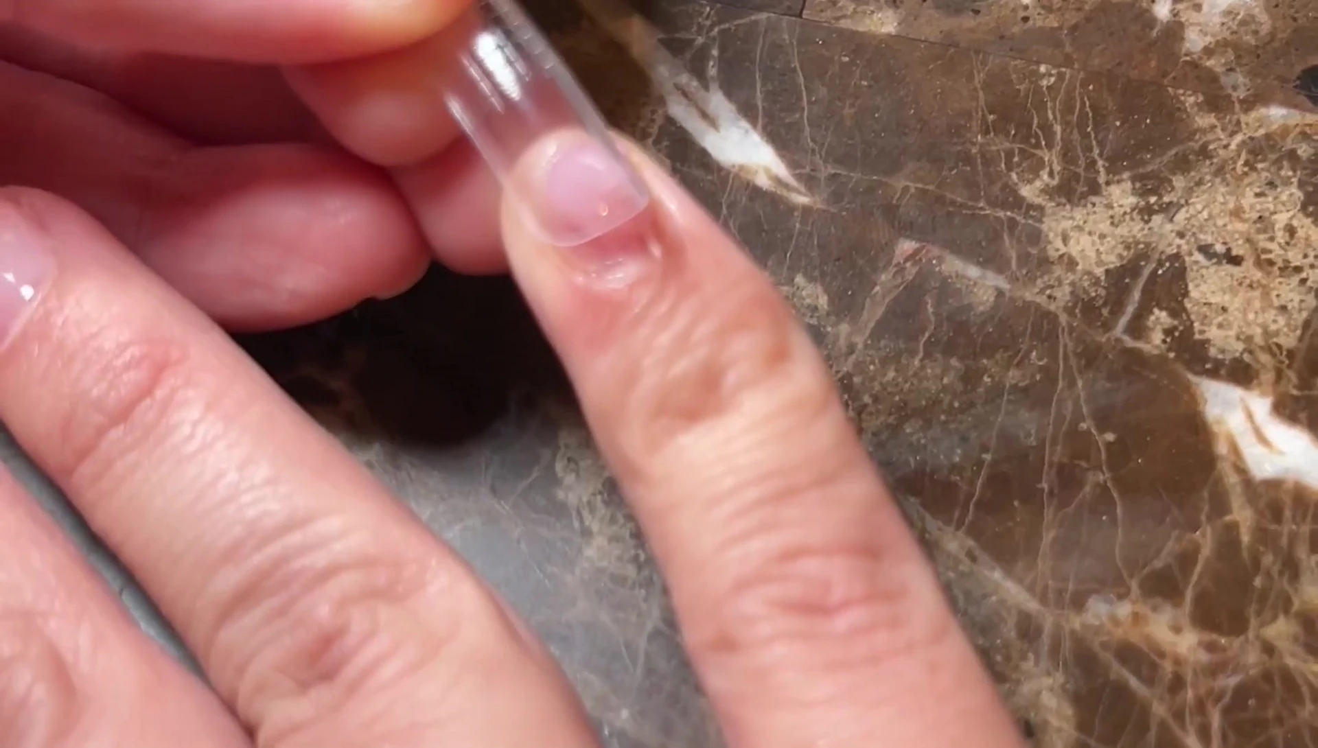 Applying the poly gel and pressing on the nail tip