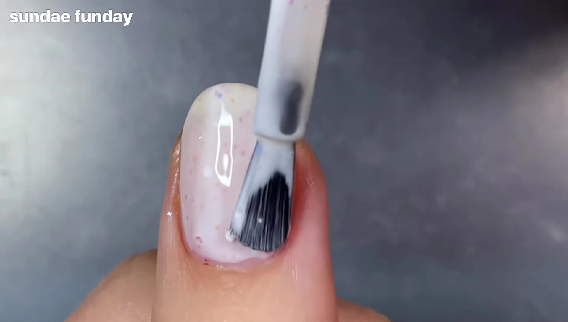 Bottle of Sunday Funday polish with the multi-colored glitter clearly visible.