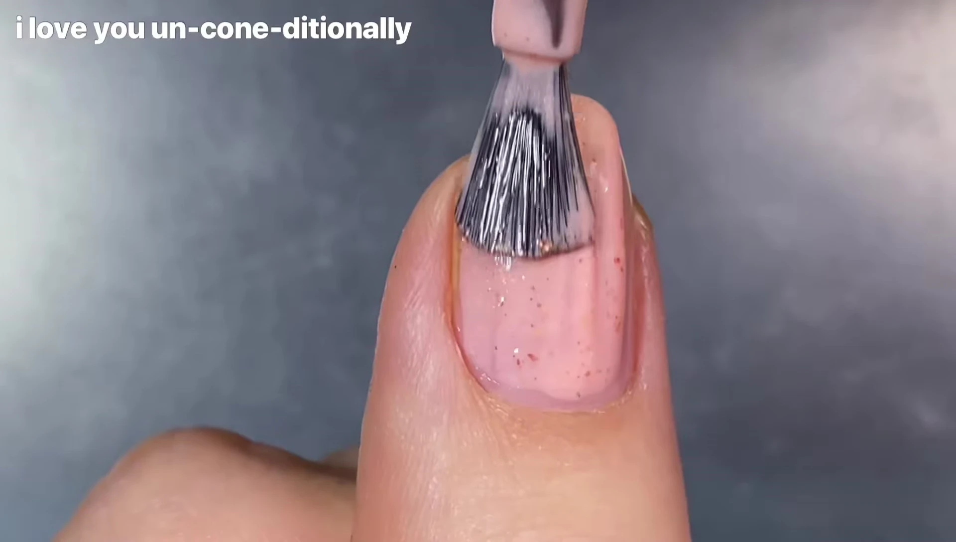Close-up shot of I Love You Unconditionally polish on nails.