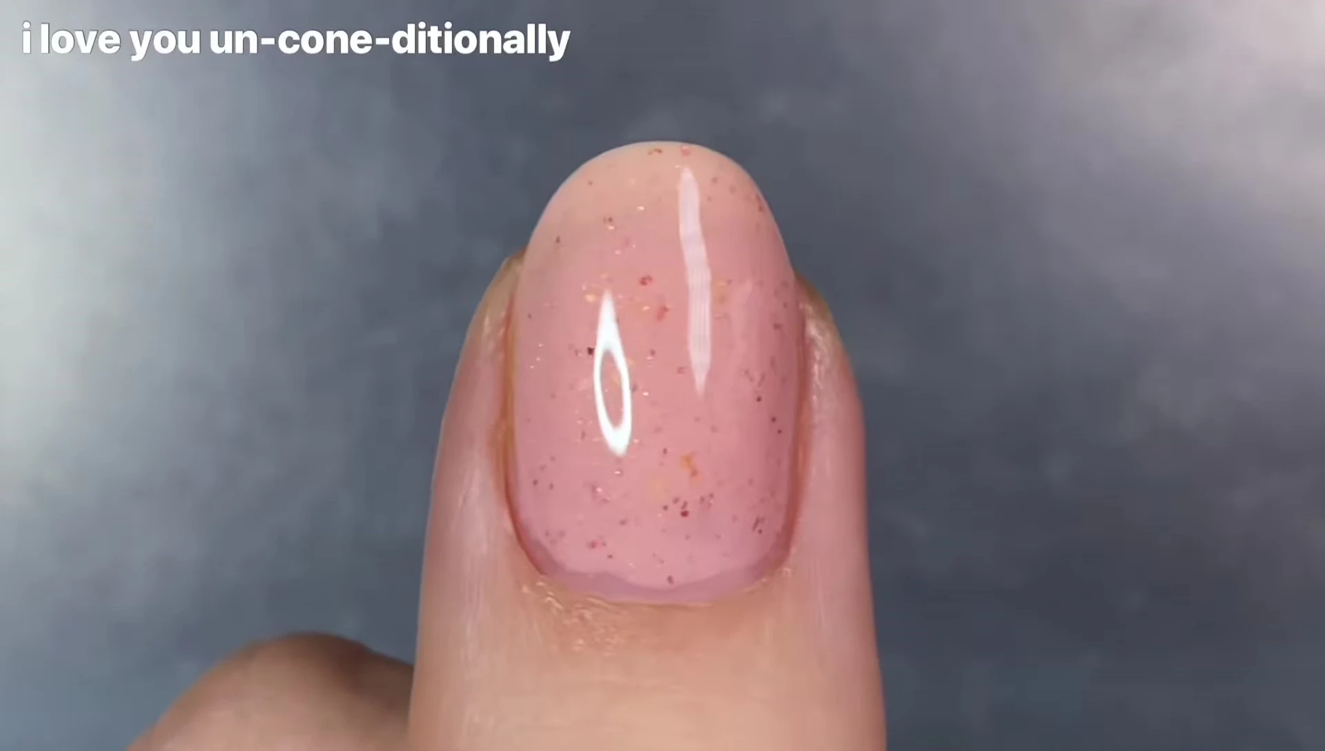 Bottle of I Love You Unconditionally polish showcasing its color and shimmer.