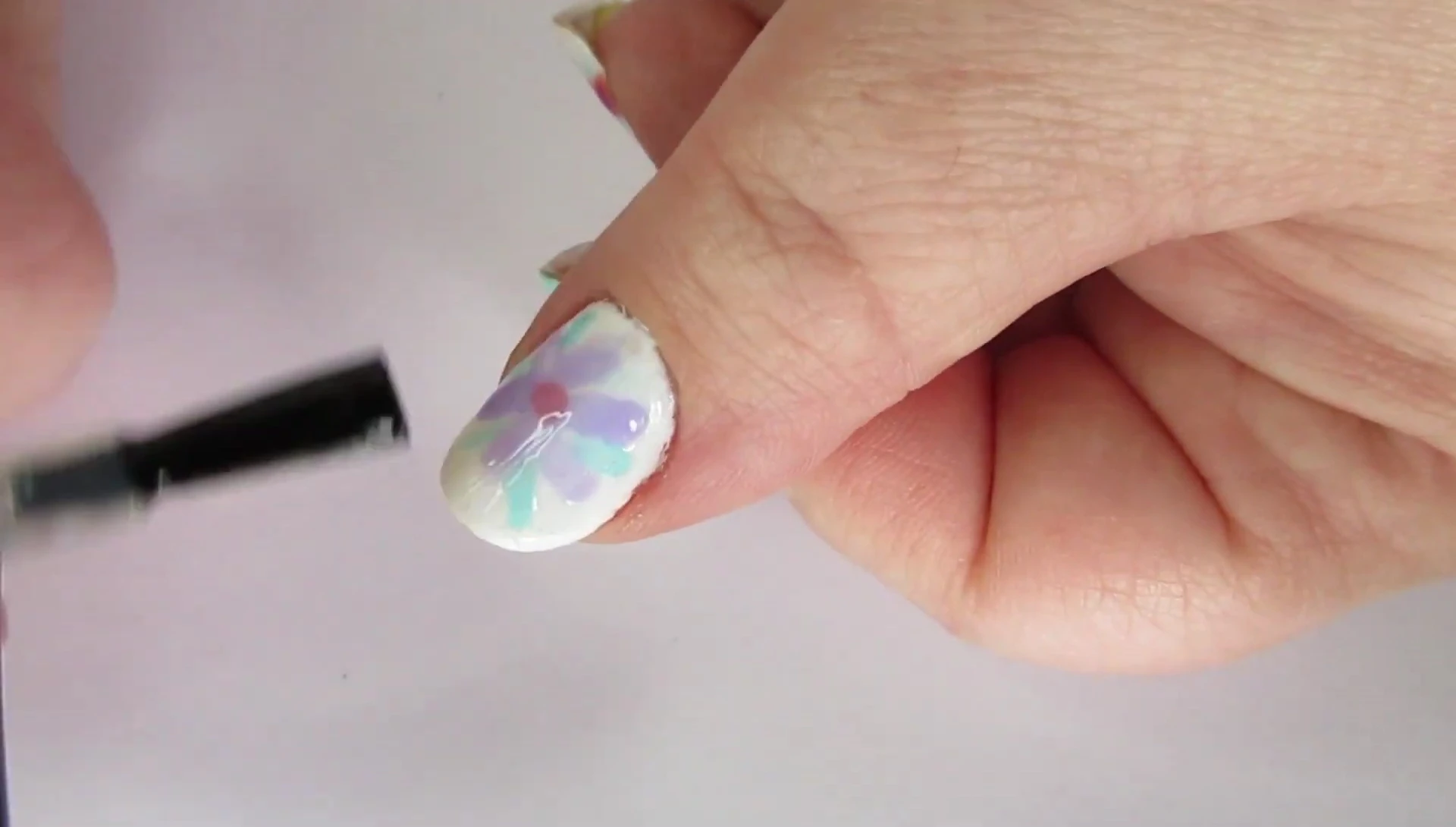Comparison of glossy and matte finishes on nails.